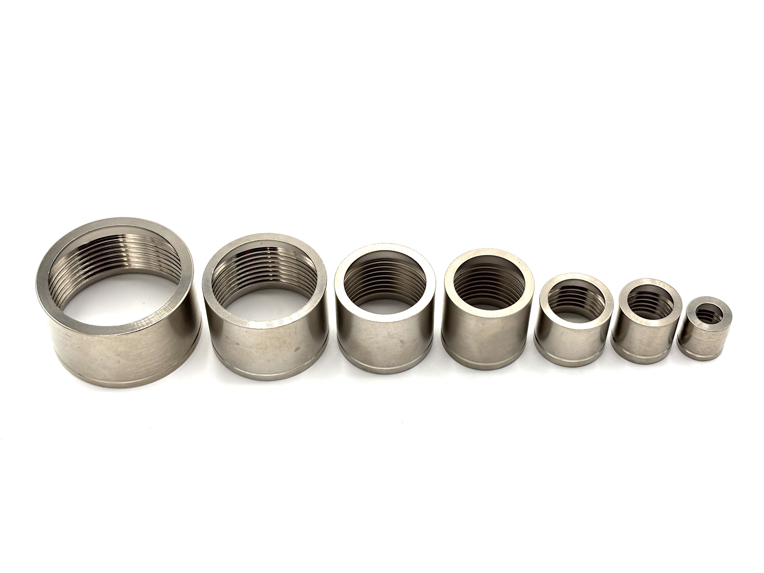XRP HS-79 PTFE crimp collar. Silver in color. Various sizes from largest to smallest, left to right.