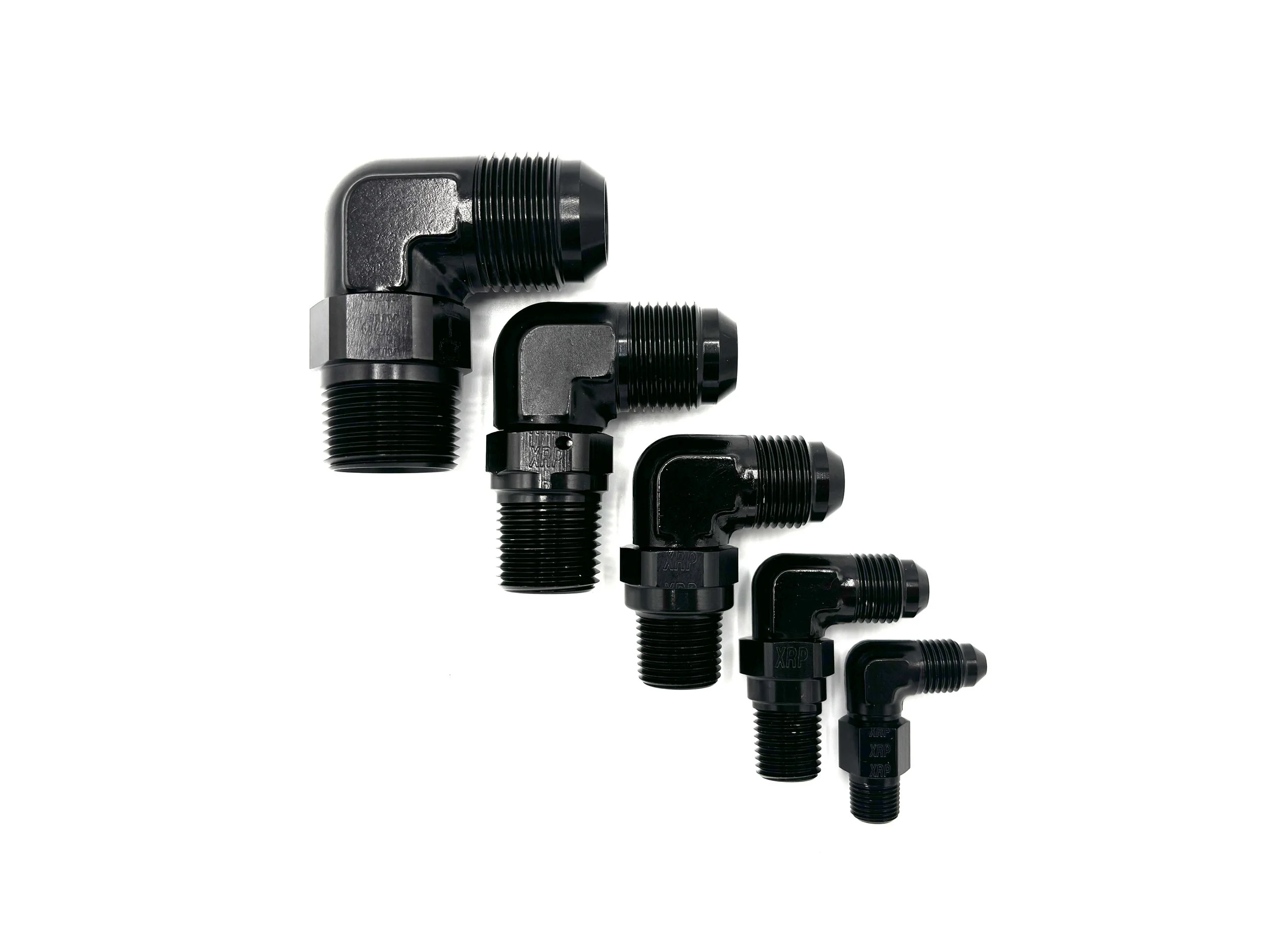 -12AN 90 Deg. Male Flare to 3/4 Pipe. Black in color. Various in a line from largest to smallest, left to right.