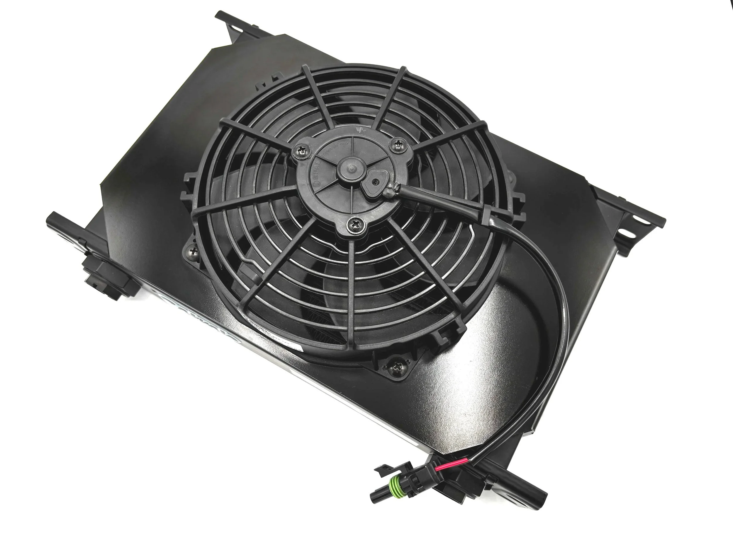 Over head view Large Black Oil cooler with fins in the middle and a large fan with a shroud