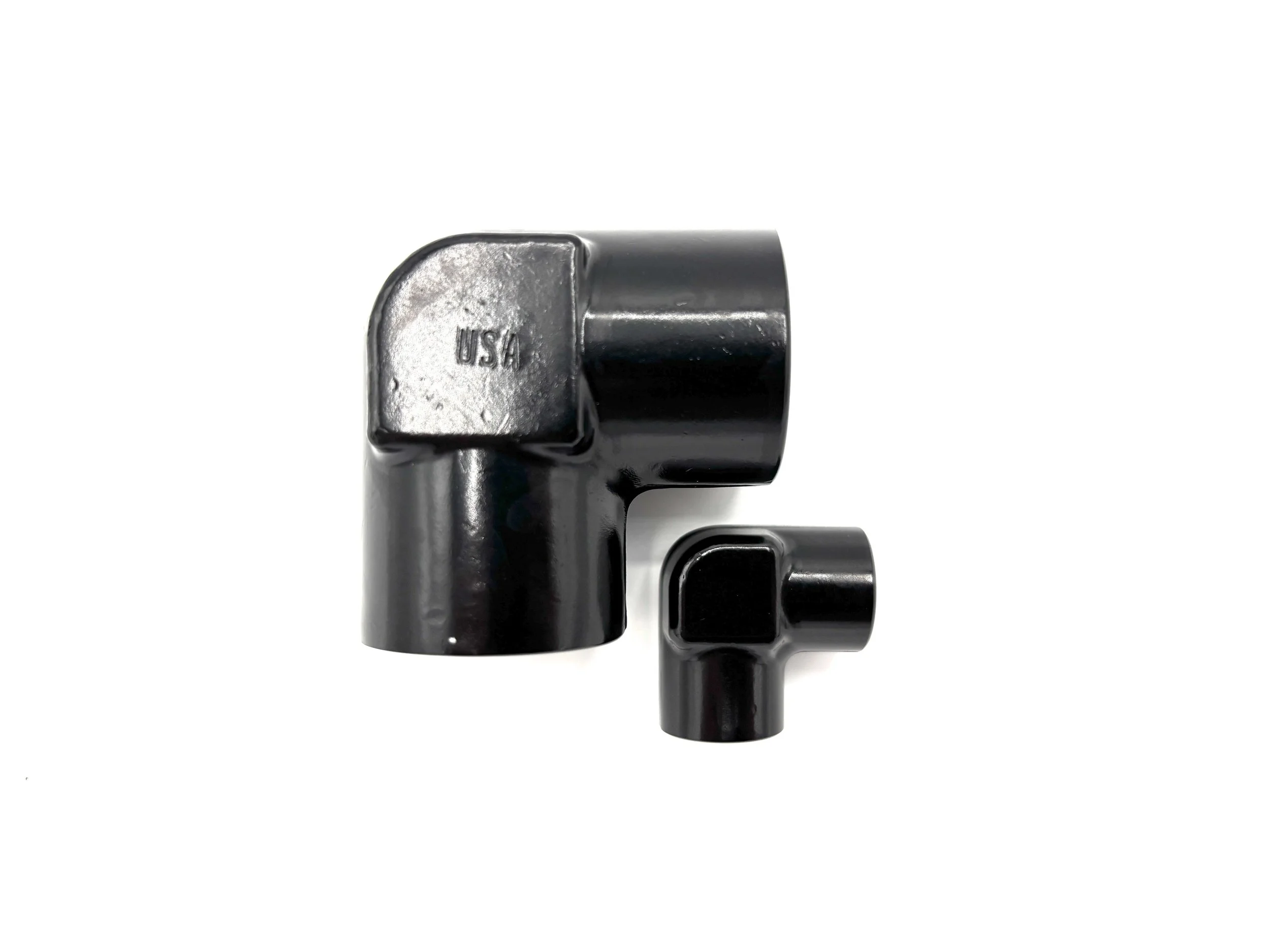 XRP 90 deg. NPT female adapter fitting. Black in color. Various sizes from largest to smallest, left to right.