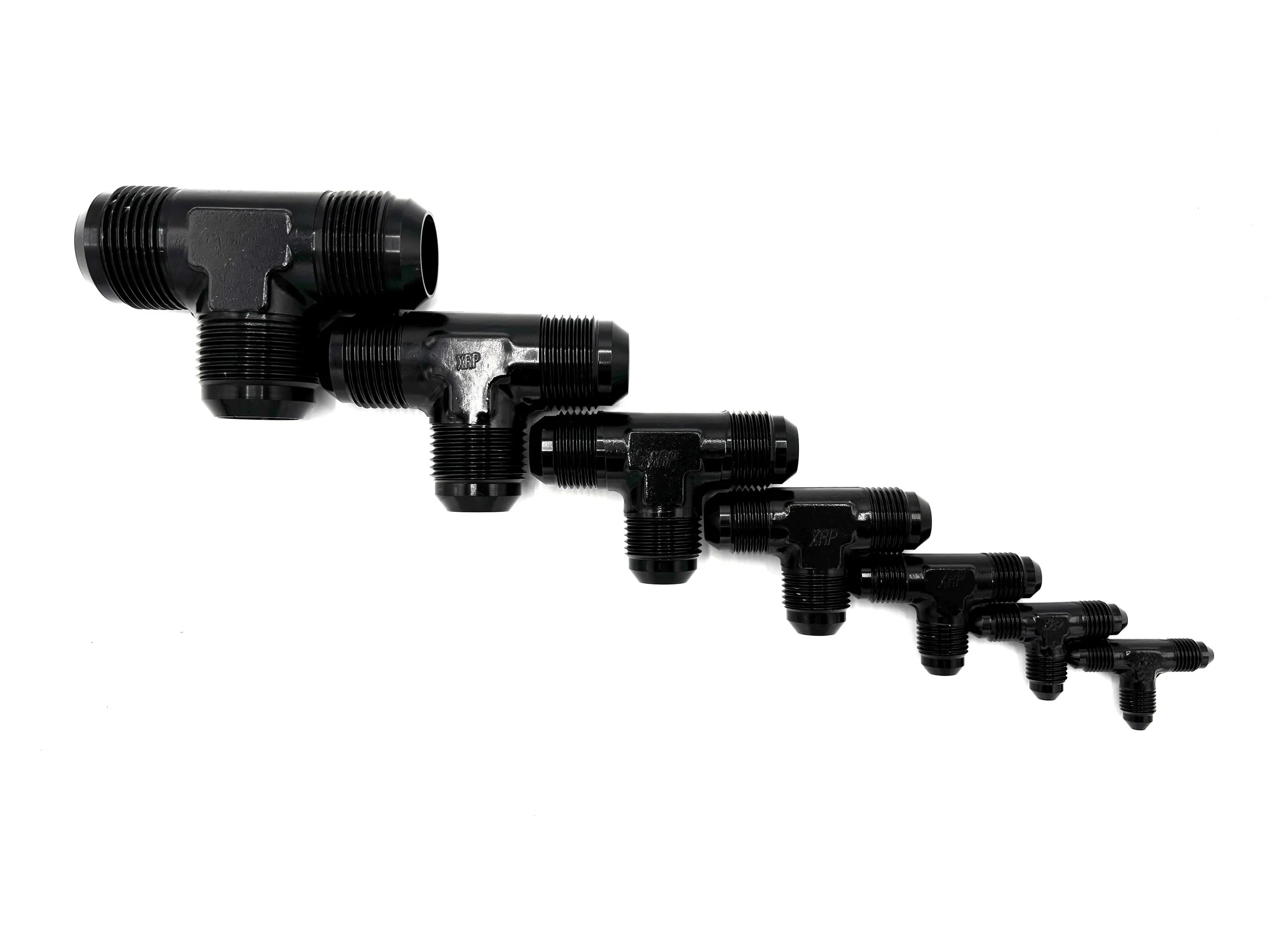 XRP AN male tee fitting. Black in color. Various sizes from largest to smallest, left to right.