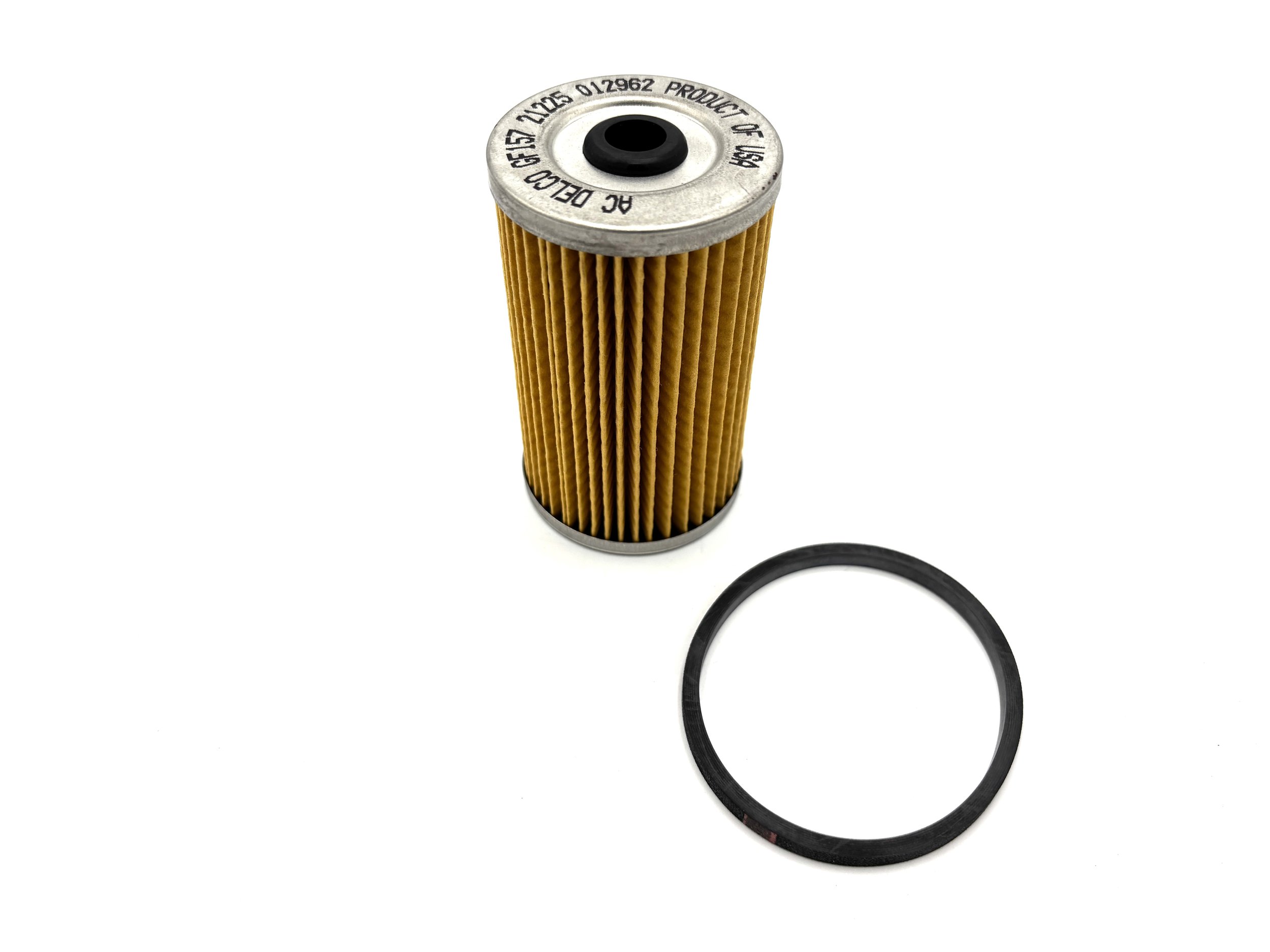 ACDelco Replacement Fuel Filter Element side view. Yellow paper in the middle with metal caps on both the top and bottom with a hole in the middle. O-ring is also next to the filter.