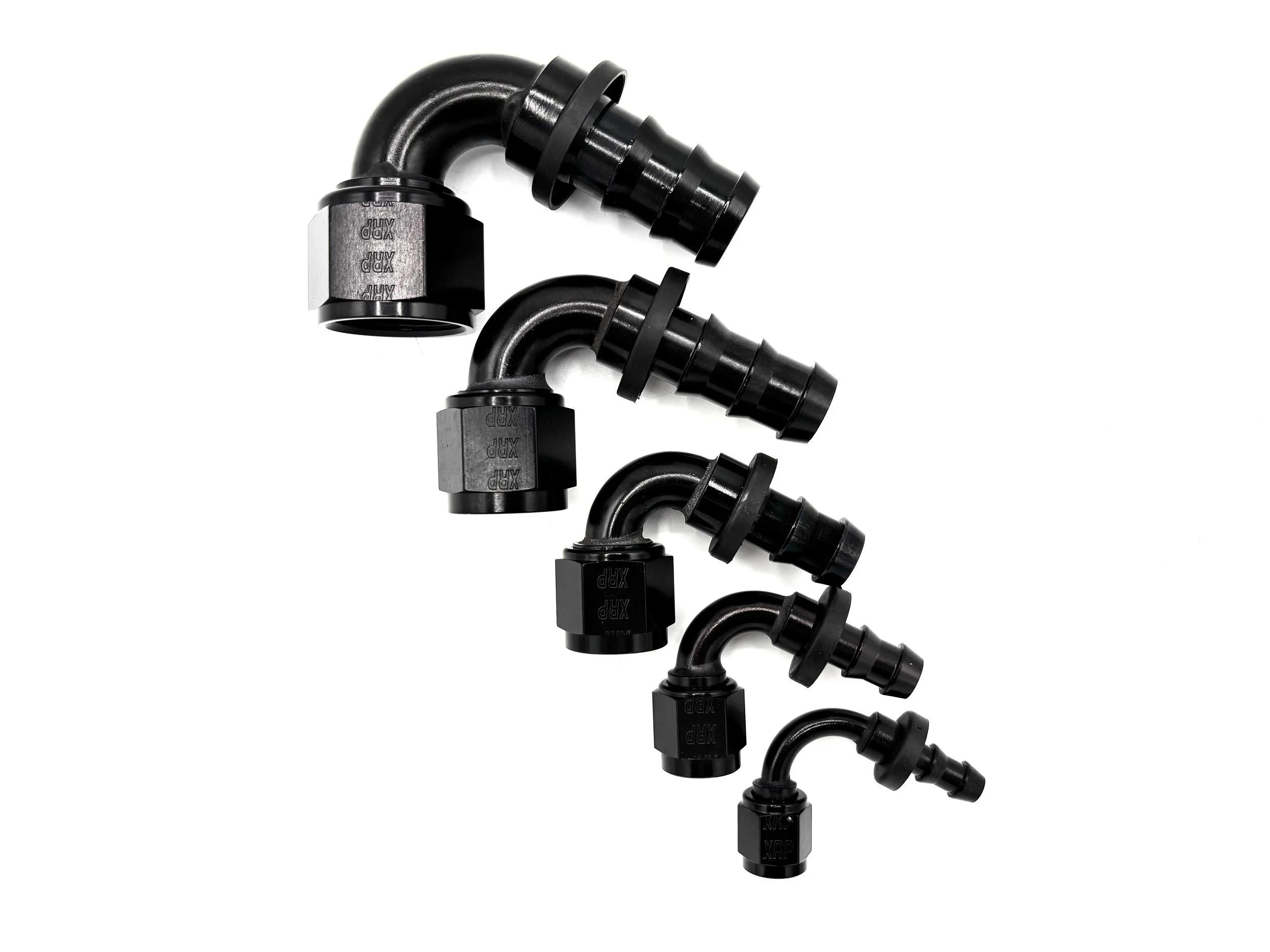 Five 120 Deg. Push Lock Hose End to AN Female Fitting black arranged in a line going from largest to smallest. The fitting has the bend going to the right with the hose end side on top.