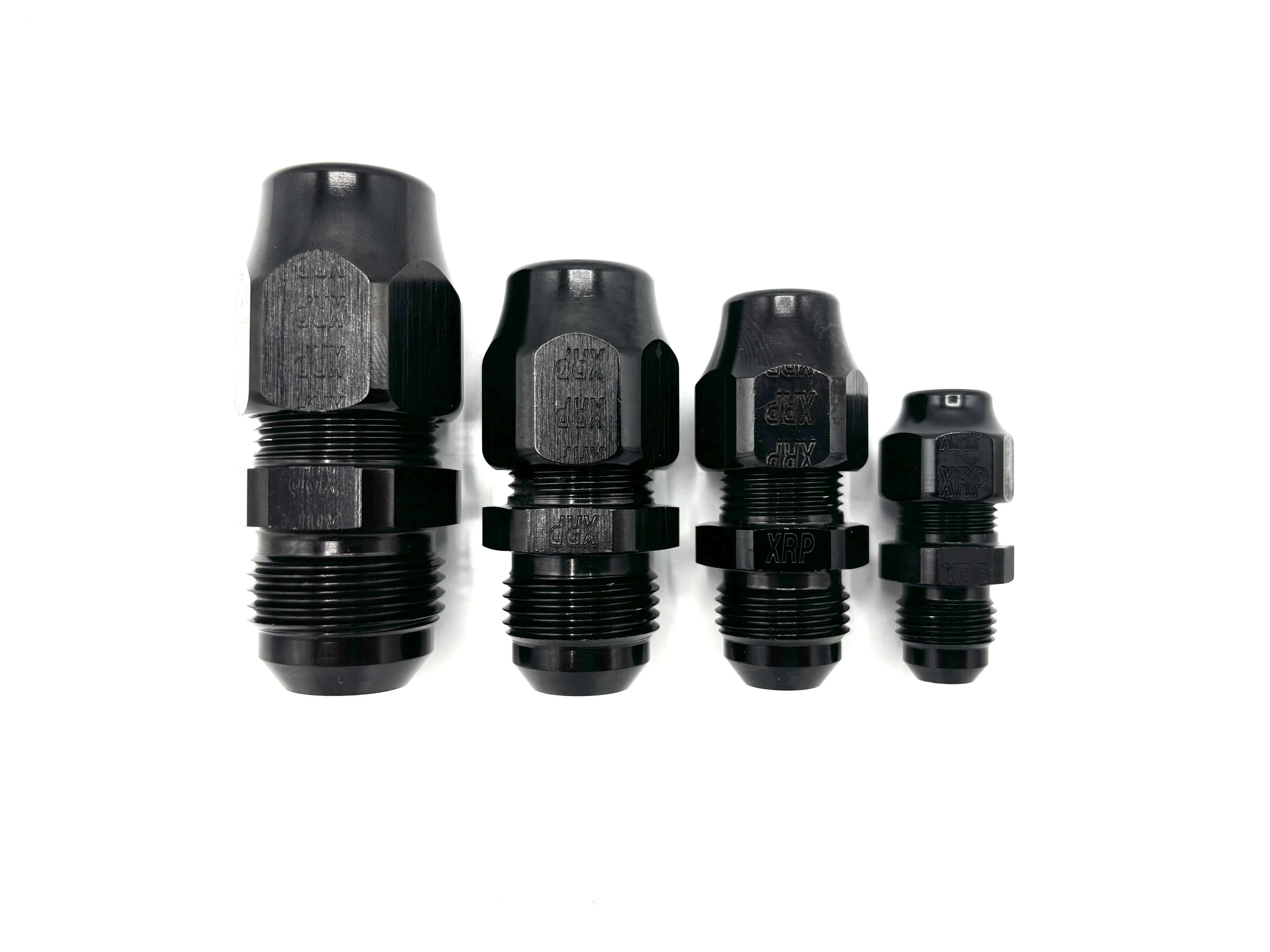 XRP -6AN male to 5/16in tube compression adapter fitting. Black in color. Various sizes from largest to smallest, left to right.