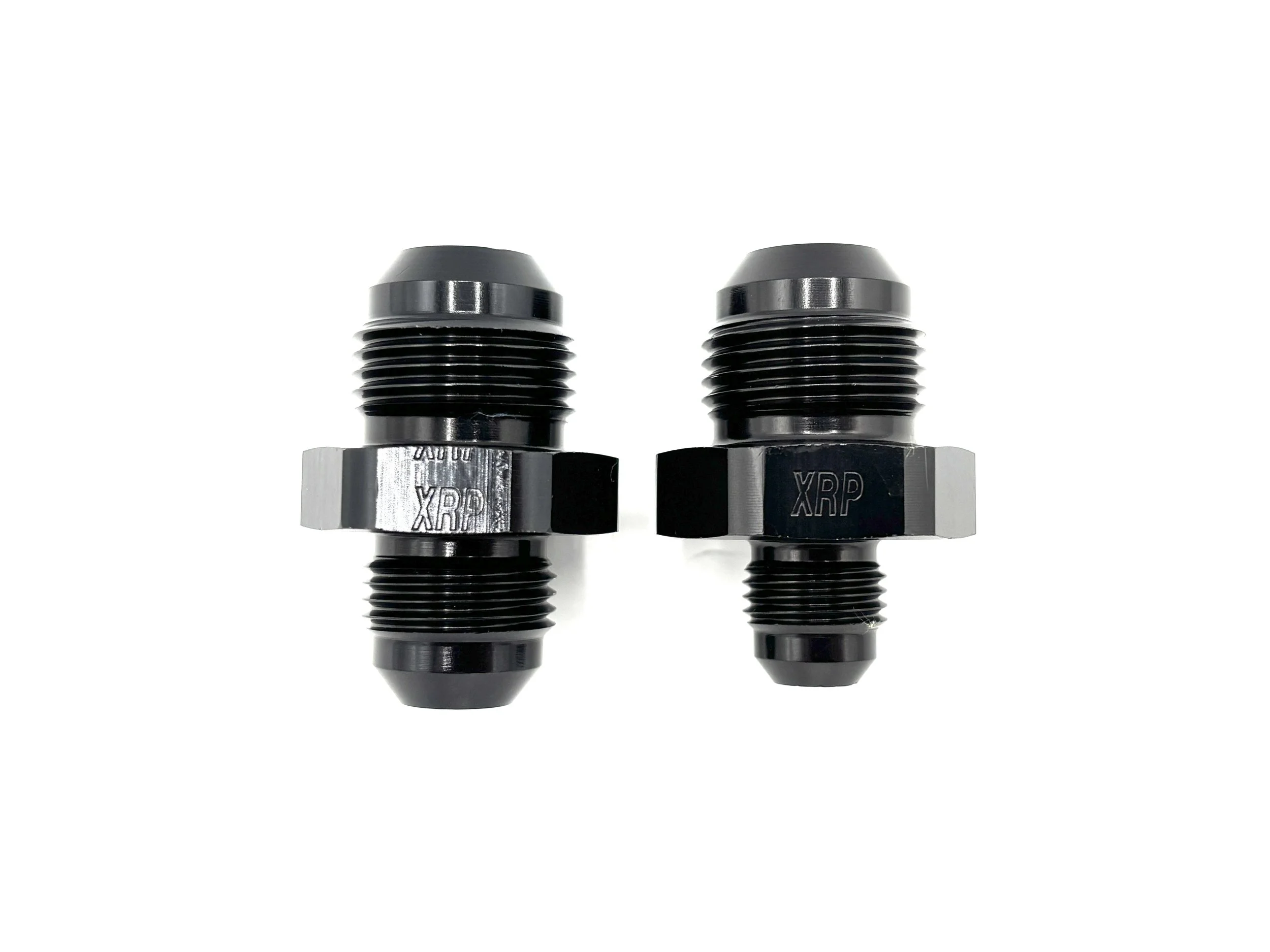 XRP straight -10AN male reducer fitting. Black in color. Various sizes from largest to smallest, left to right.