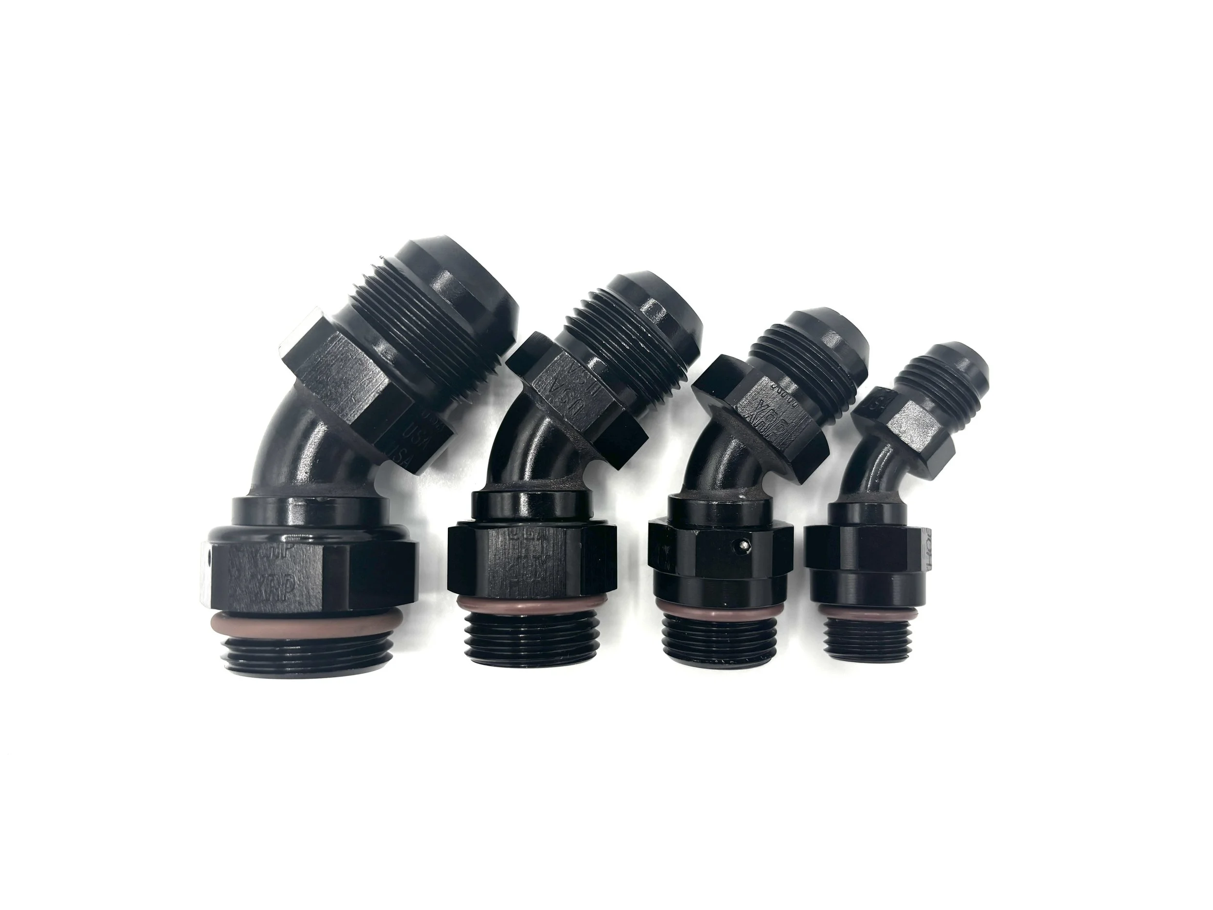XRP 45 Deg. AN Male to ORB Fitting. Black in Color. Brown O-ring on the bottom. Various sizes, largest to smallest, left to right.