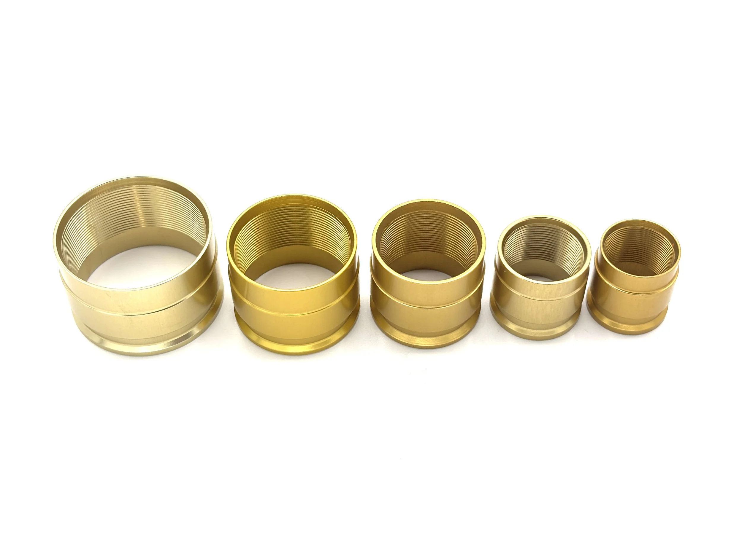 XRP ProPlus PTFE crimp collar. Gold in color. Various sizes from largest to smallest, left to right.