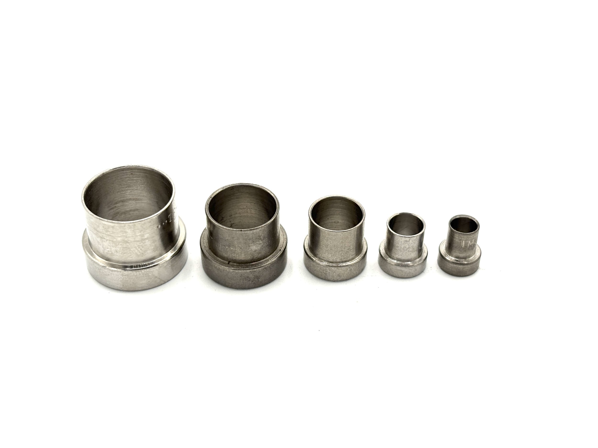 Stainless steel tube sleeve. Silver in color. Various sizes from largest to smallest, left to right.