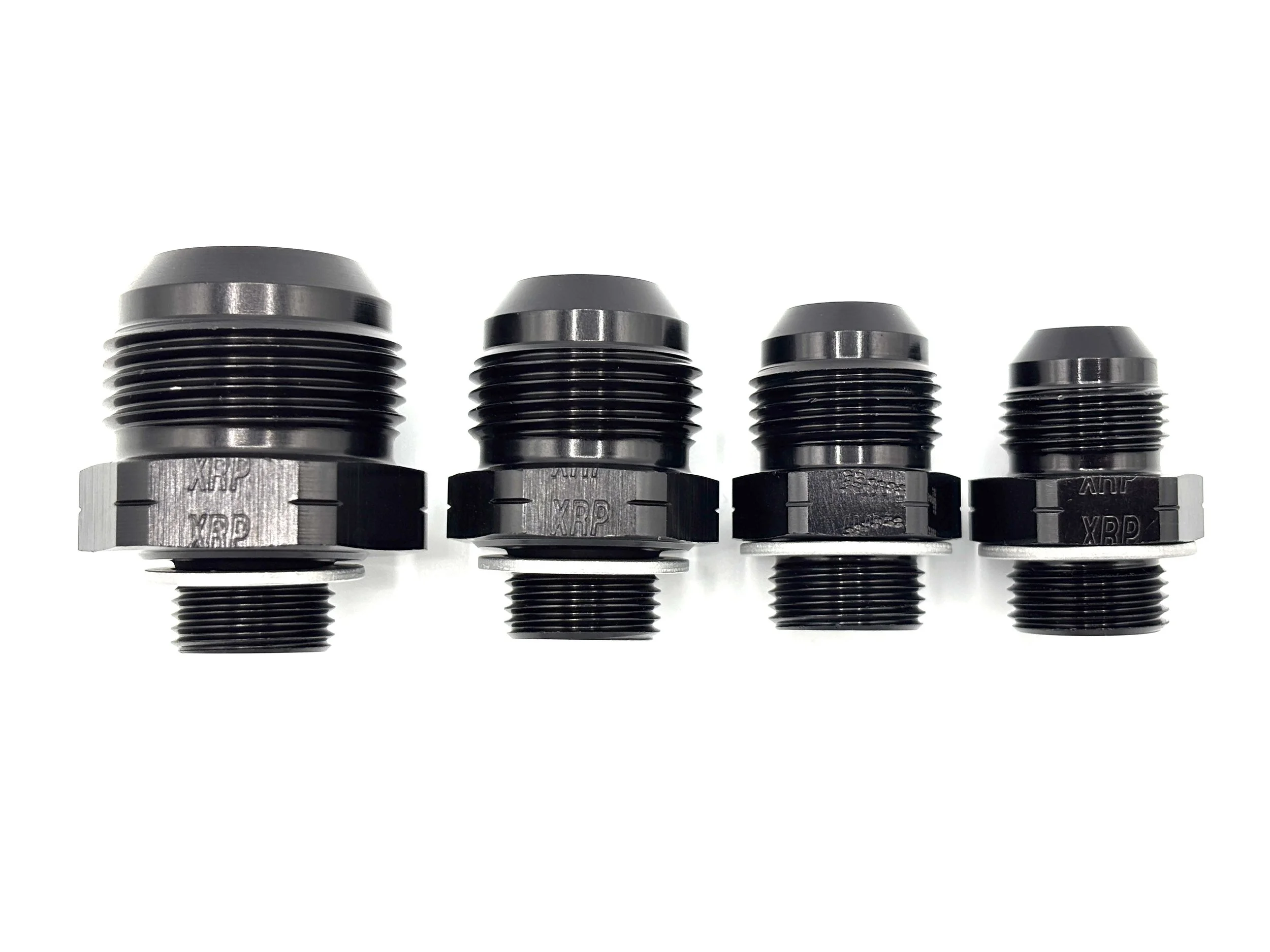 XRP straight AN male to M18 x 1.5 male with crush washer. Black in color. Various sizes from largest to smallest, left to right.