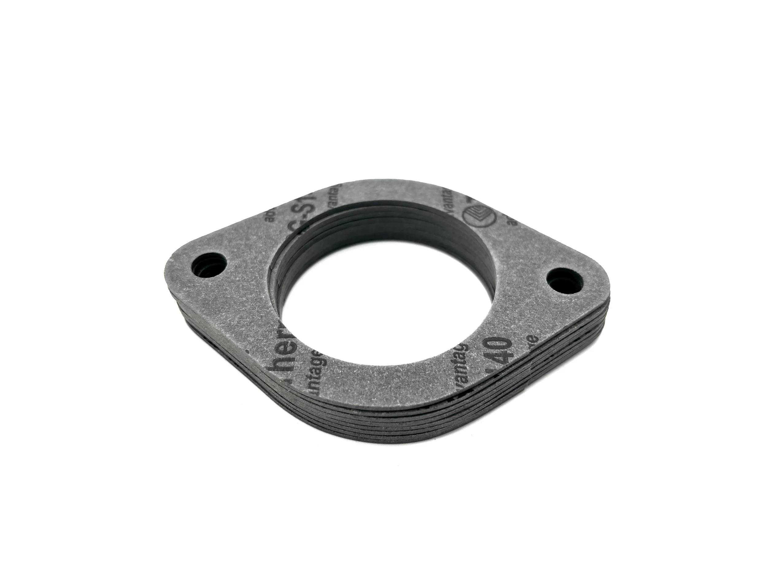 Black Phenolic Carburetor spacer. Circular in shape with one big hole in the middle and two bolt holes on the side. Gray gasket is on top and bottom.