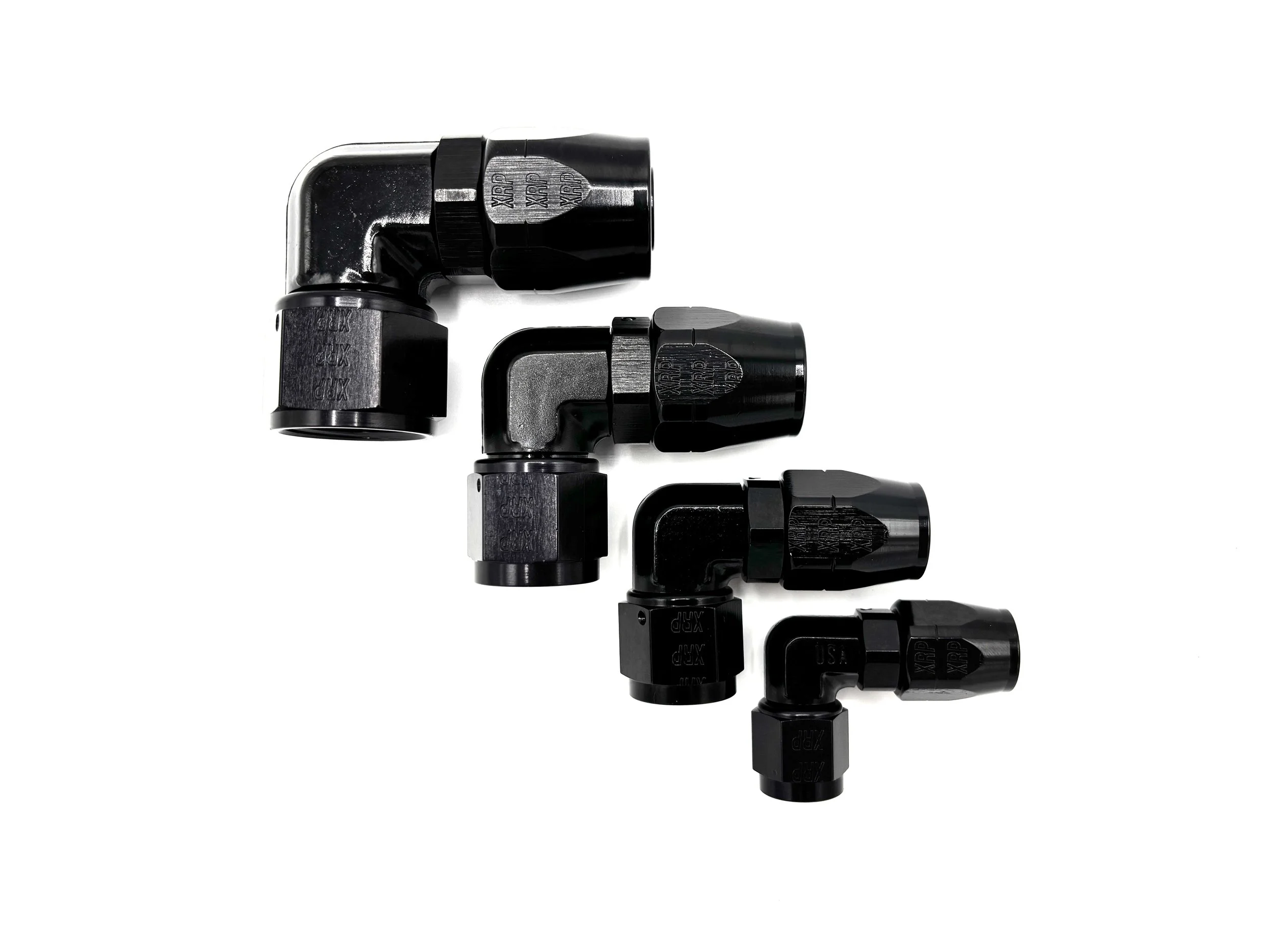 Four 90 Deg. Forged Swivel Hose End to AN Female fittings black. The bends are going towards the right. They are arranged in a line from largest to smallest.