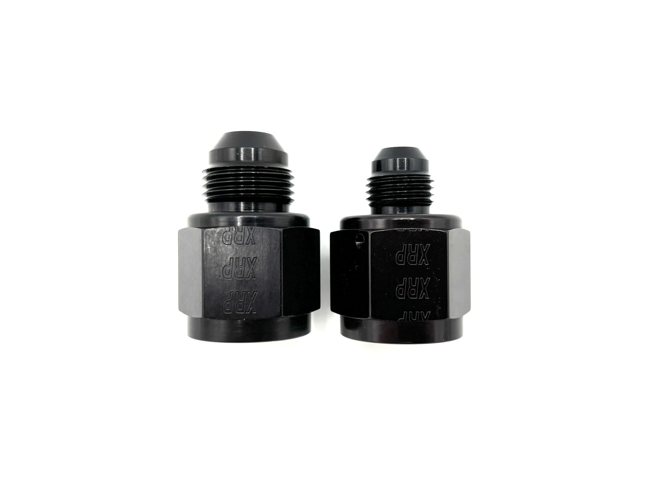 XRP straight -10AN female to AN male reducer fitting. Black in color. Various sizes from largest to smallest, left to right.