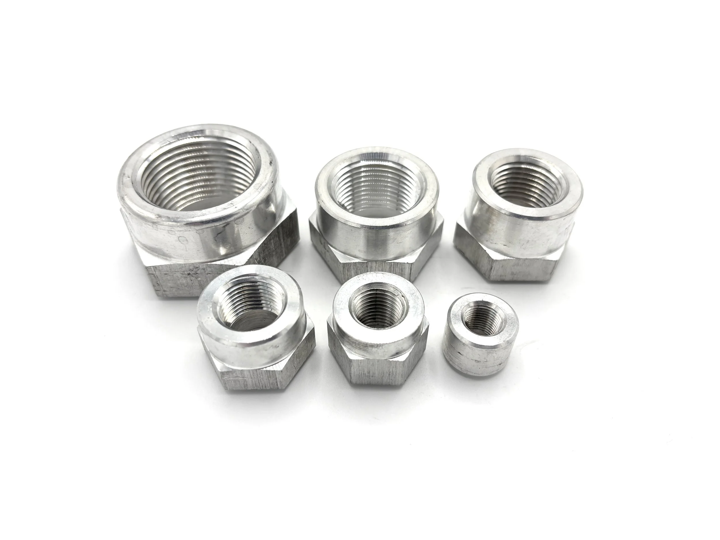 XRP NPT female aluminum weld bung. Silver in color. Various sizes from largest to smallest, left to right.