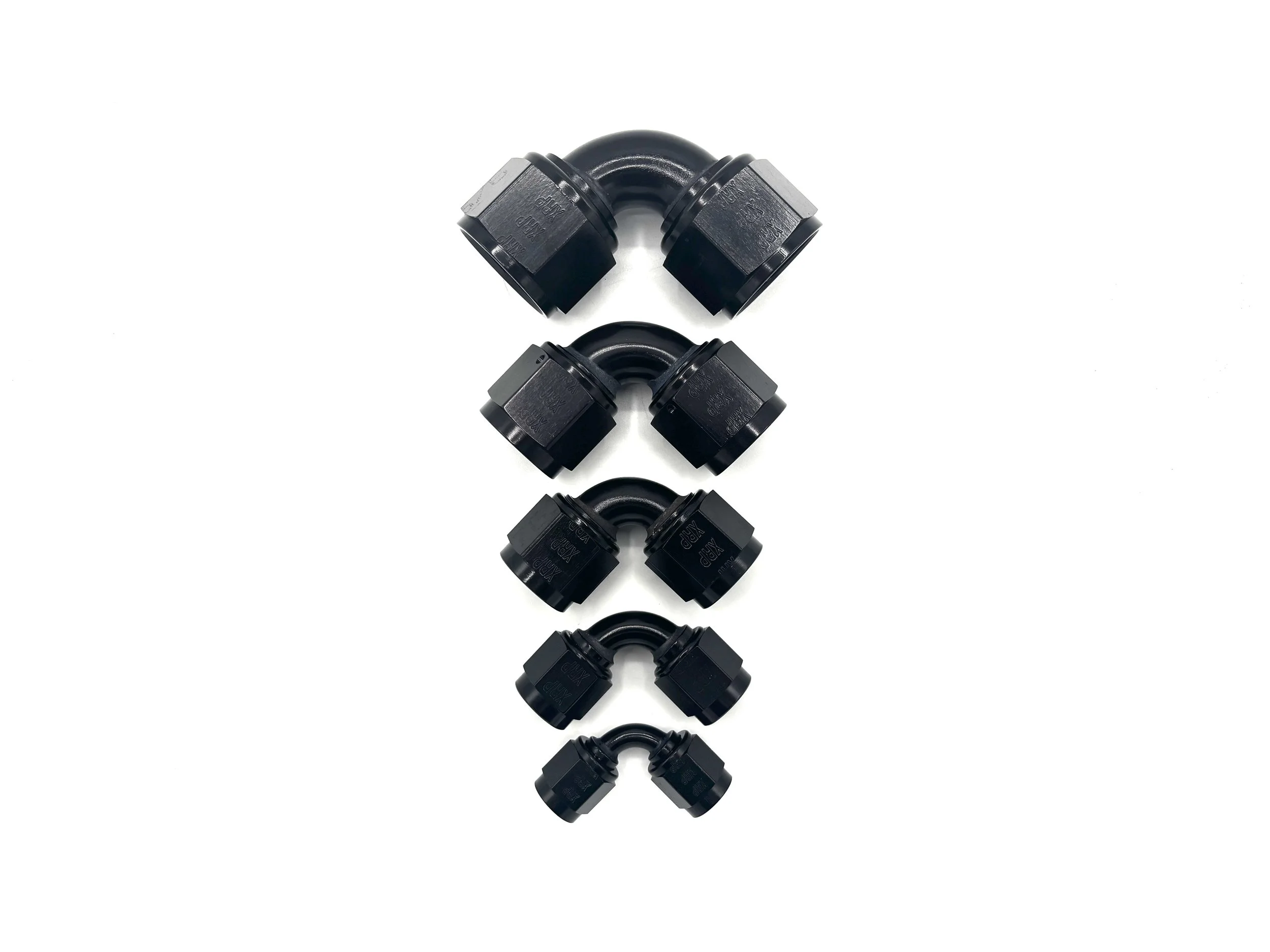 XRP 90 deg. -12 AN female to -12 AN female coupler. Black in color. Various in a line from largest to smallest, top to bottom.
