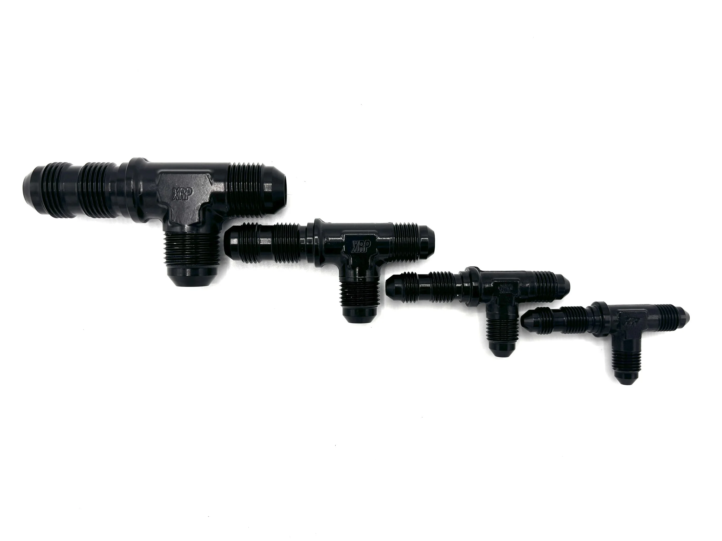 XRP Bulkhead Tee on Run. Black in color. In the shape of a "T". Various sizes from largest to smallest, left to right.