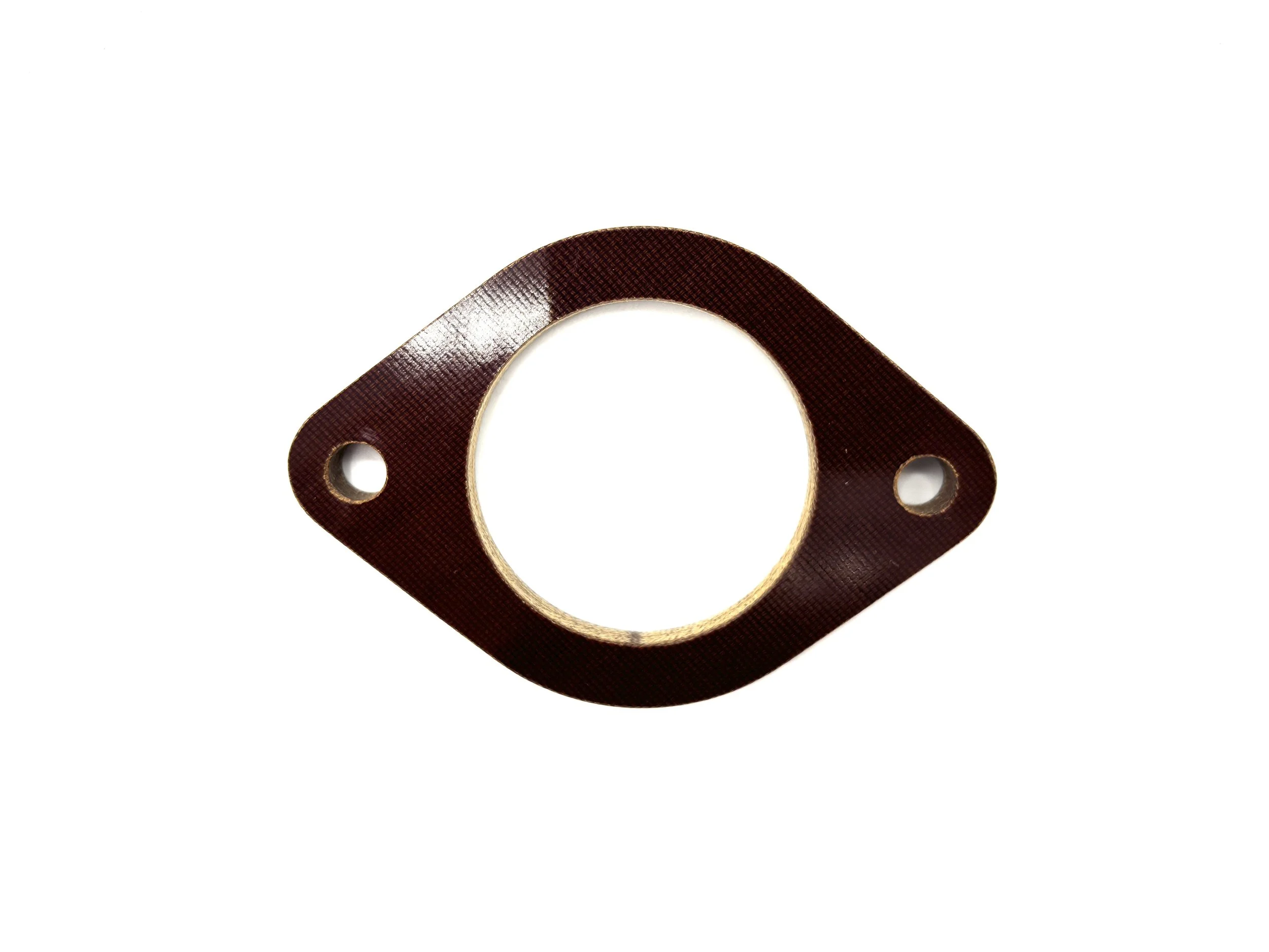 Brown Phenolic Carburetor spacer. Circular in shape with one big hole in the middle and two bolt holes on the side.