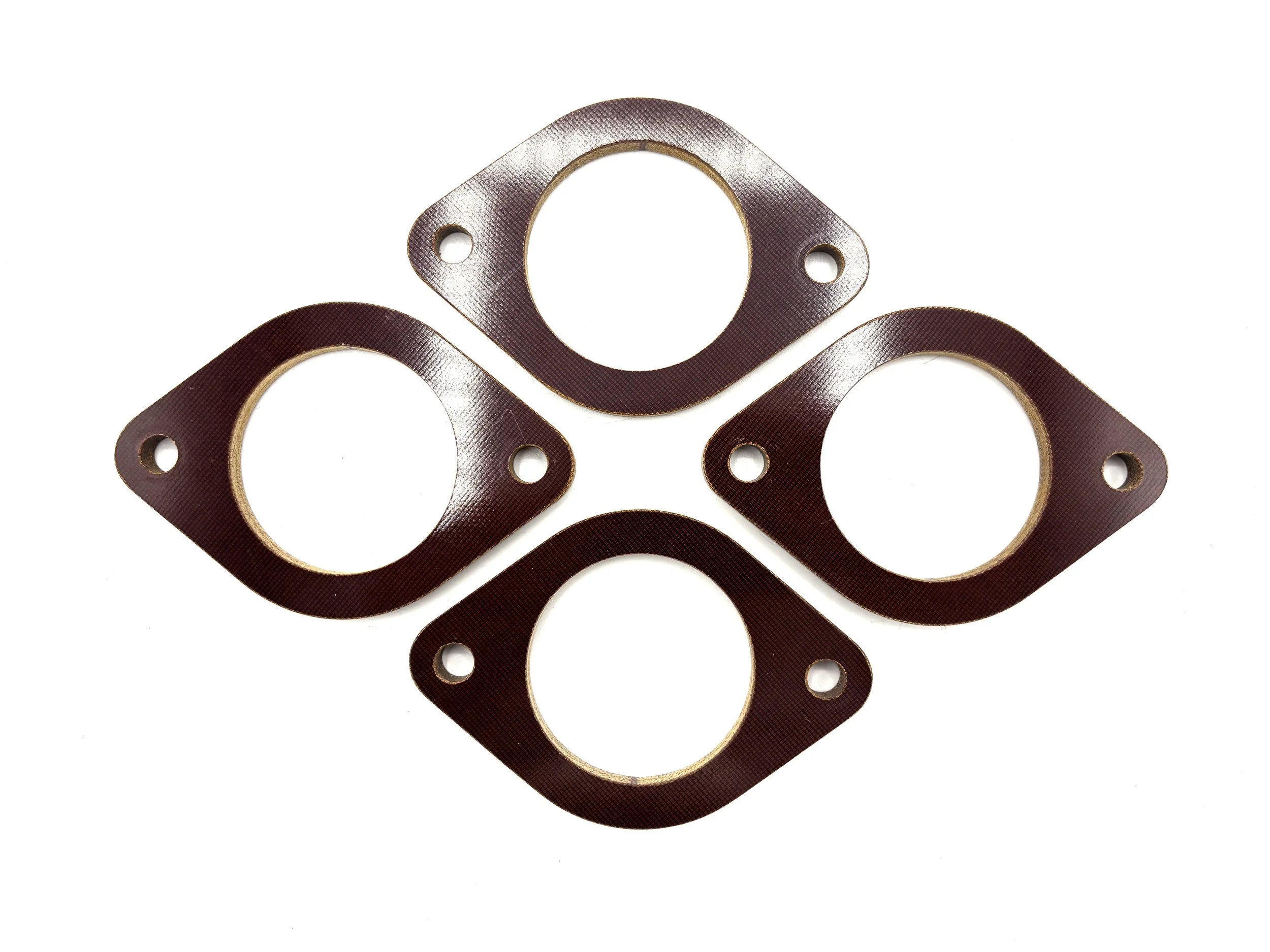 Four Brown Phenolic Carburetor spacer. Circular in shape with one big hole in the middle and two bolt holes on the side.