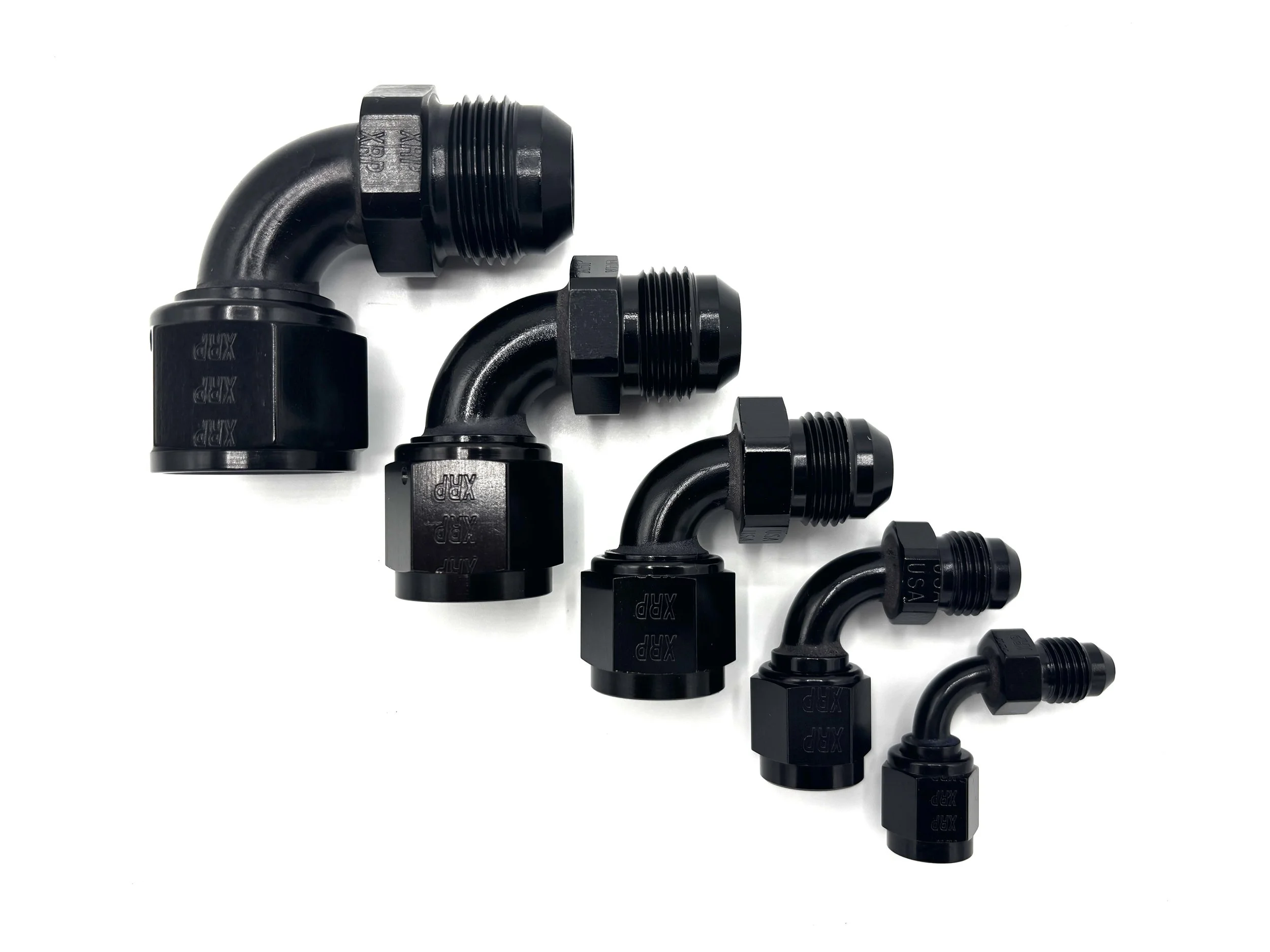 -12AN 90 deg. AN female swivel to AN male adapter. Black in color. Various sizes in a line from largest to smallest, left to right.