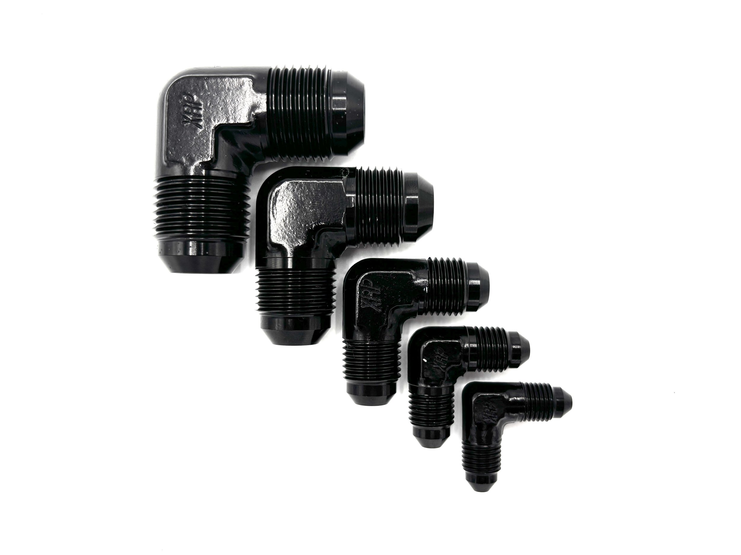 XRP 90 deg. AN male to AN male adapter fitting. Black in color. Various sizes from largest to smallest, left to right.