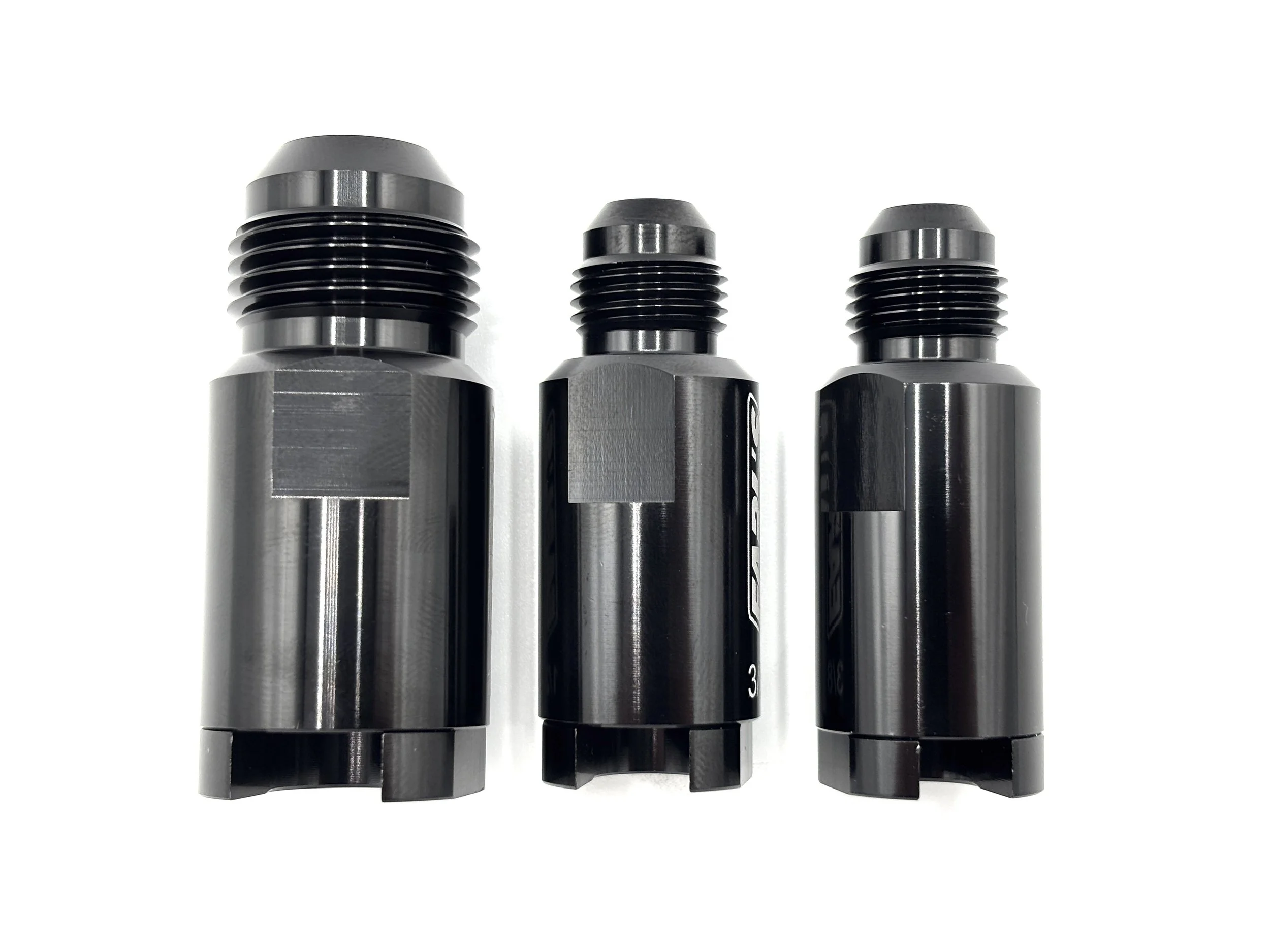 Earl's AN male to OE fuel line quick connect adapter. Black in color. Various sizes from largest to smallest, left to right.