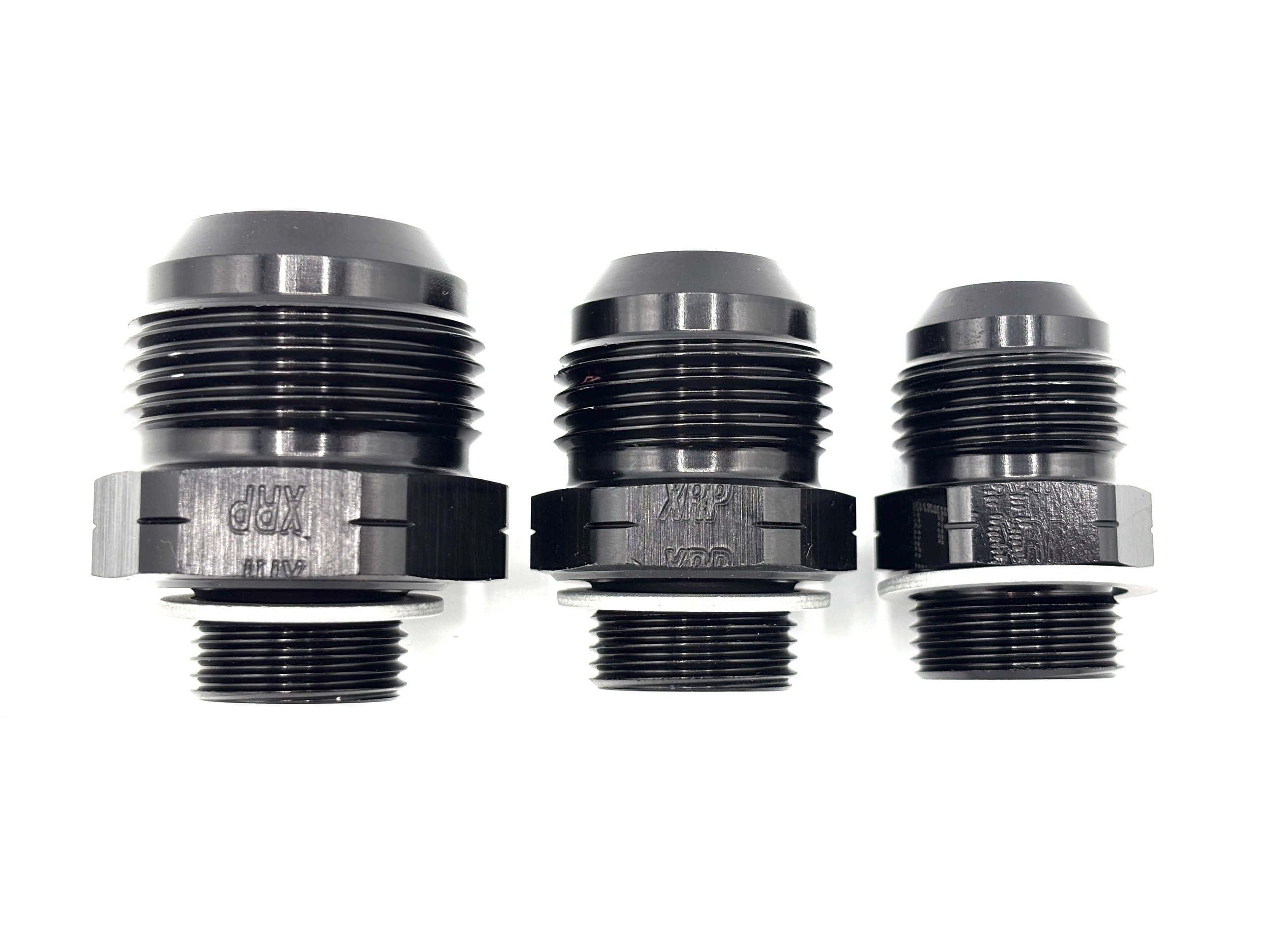 XRP straight AN male to M20 x 1.5 male with crush washer. Black in color. Various sizes from largest to smallest, left to right.