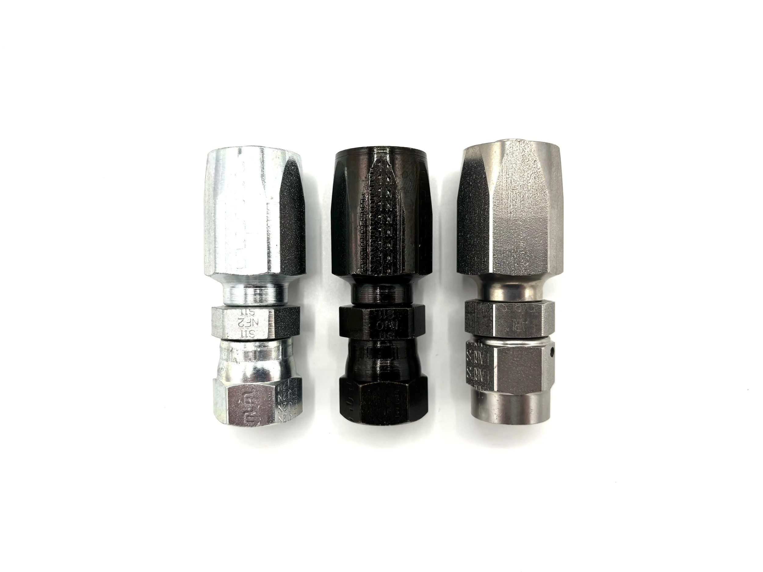 Three power steering hose ends next to each other. All different materials/ colors.