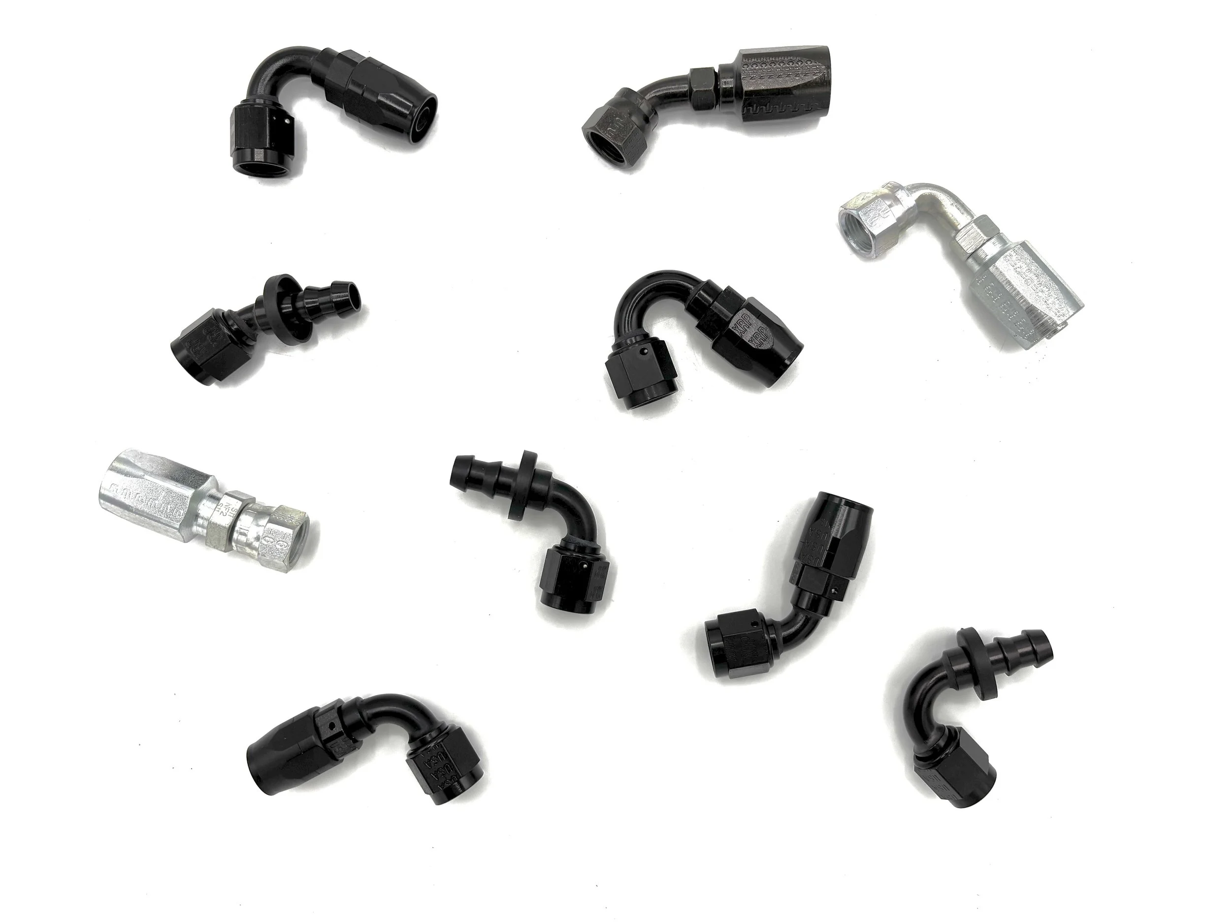 Miscellaneous AN hose ends spread out on a white background.