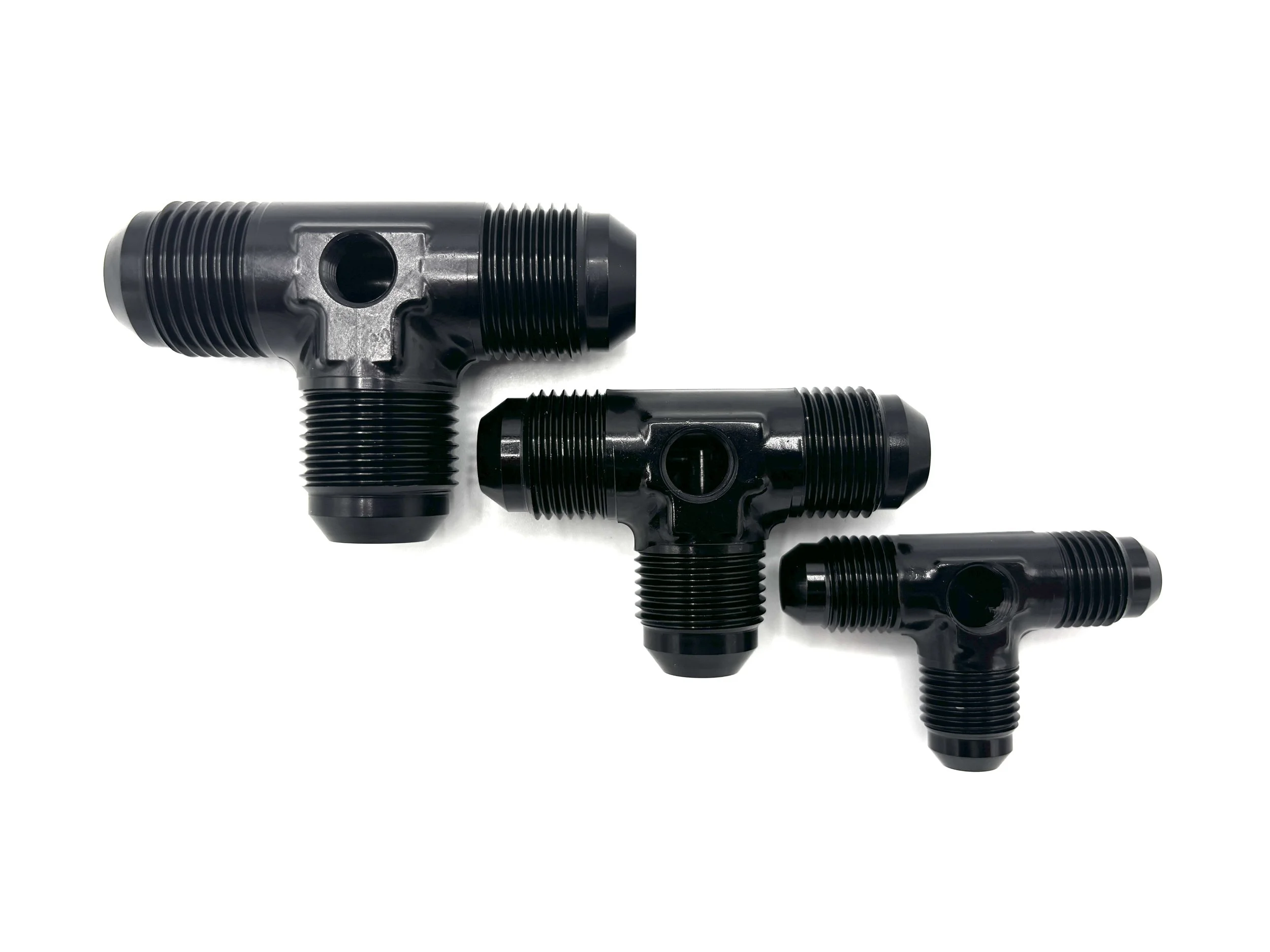 AN Male Tee with 1/8NPT Female Port. Black in color. In the shape of a T. Multiple in descending order in size.