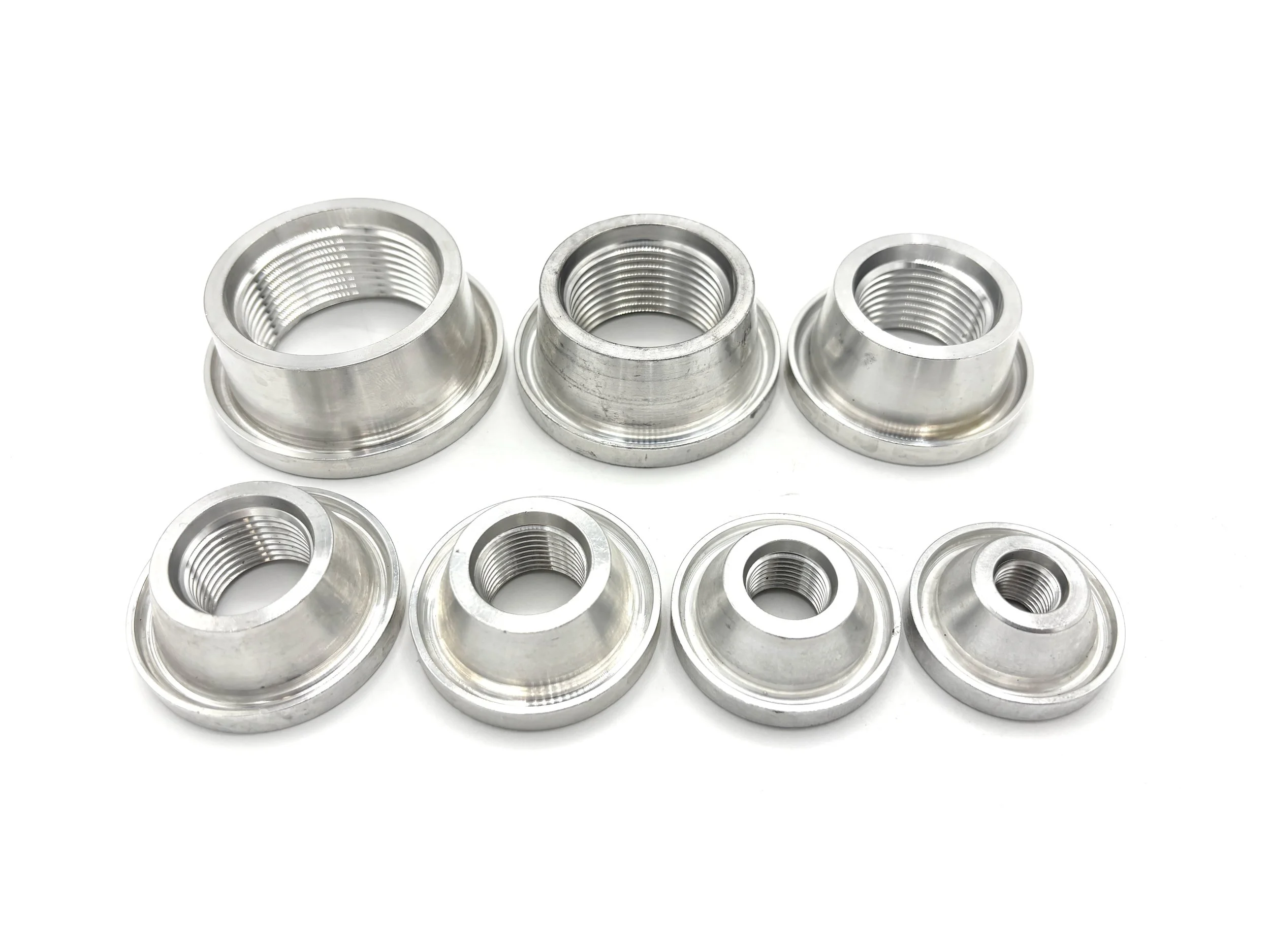 XRP o-ring boss female aluminum welding bung. Silver in color. Various sizes from largest to smallest, left to right.