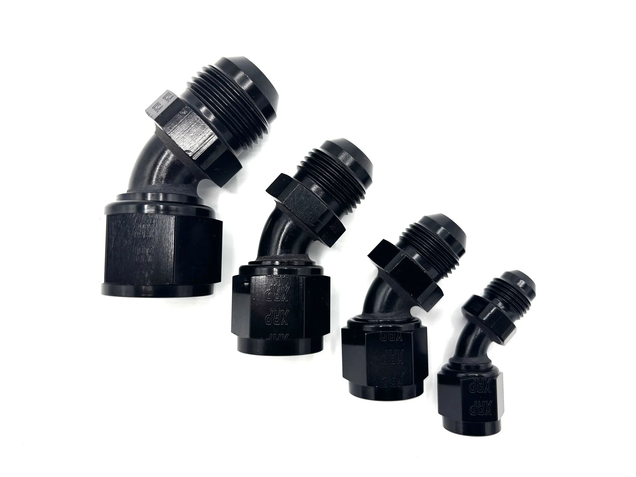 -12AN 45 deg. AN female swivel to AN male adapter. Black in color. Various sizes in a line from largest to smallest, left to right.