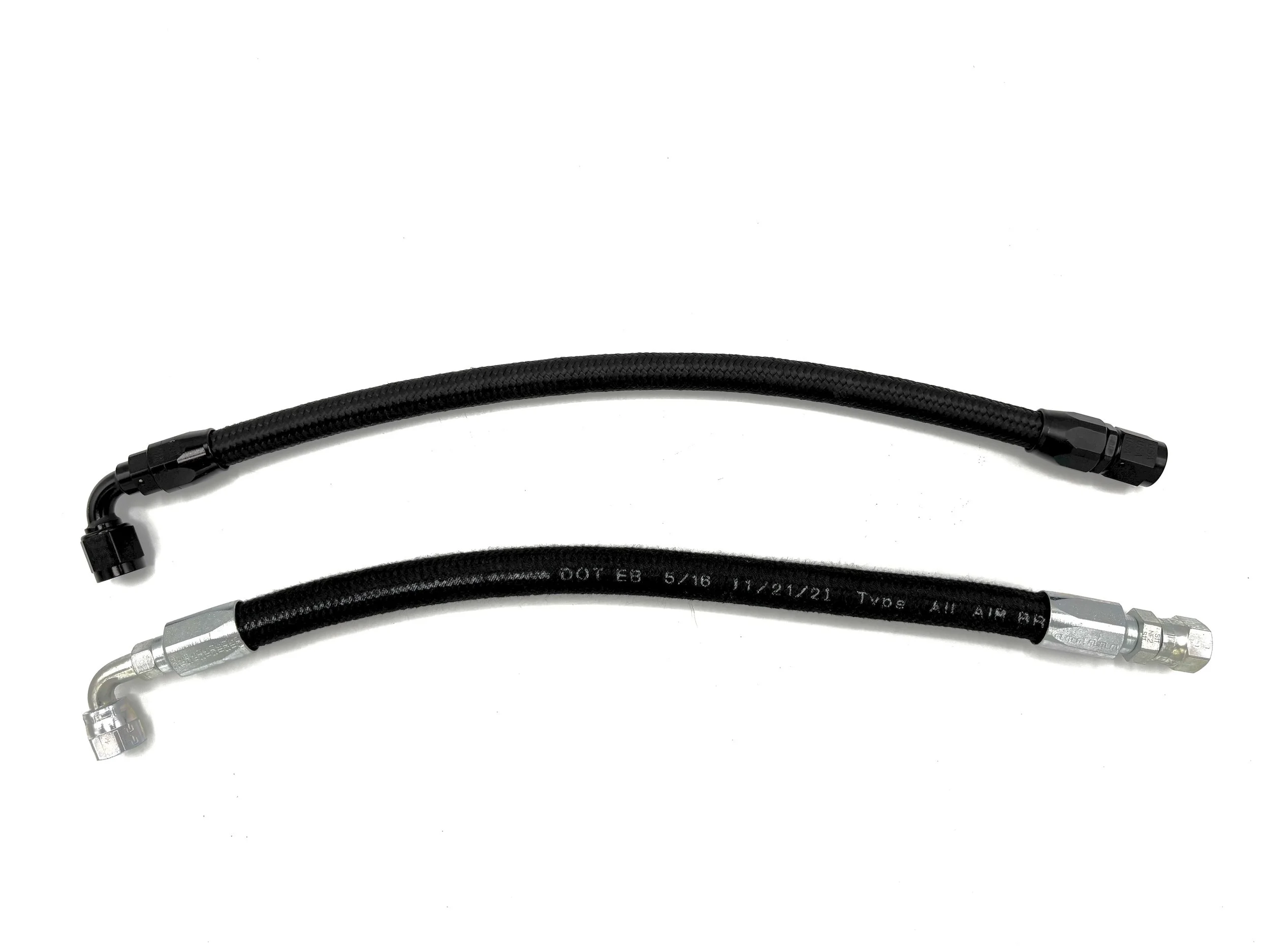 Two AN hoses with AN fittings in them. The top hose is black with traditional black fittings, and the bottom hose is black with white text and silver color fittings.