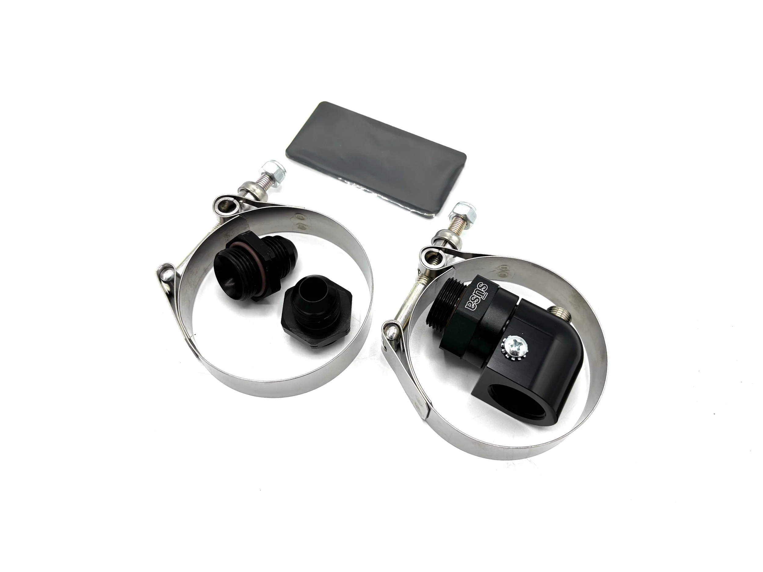 Complete Contents of cooler kit. 2 clamps, 2 orb fittings, 1 rubber pad, 1 port adapter.