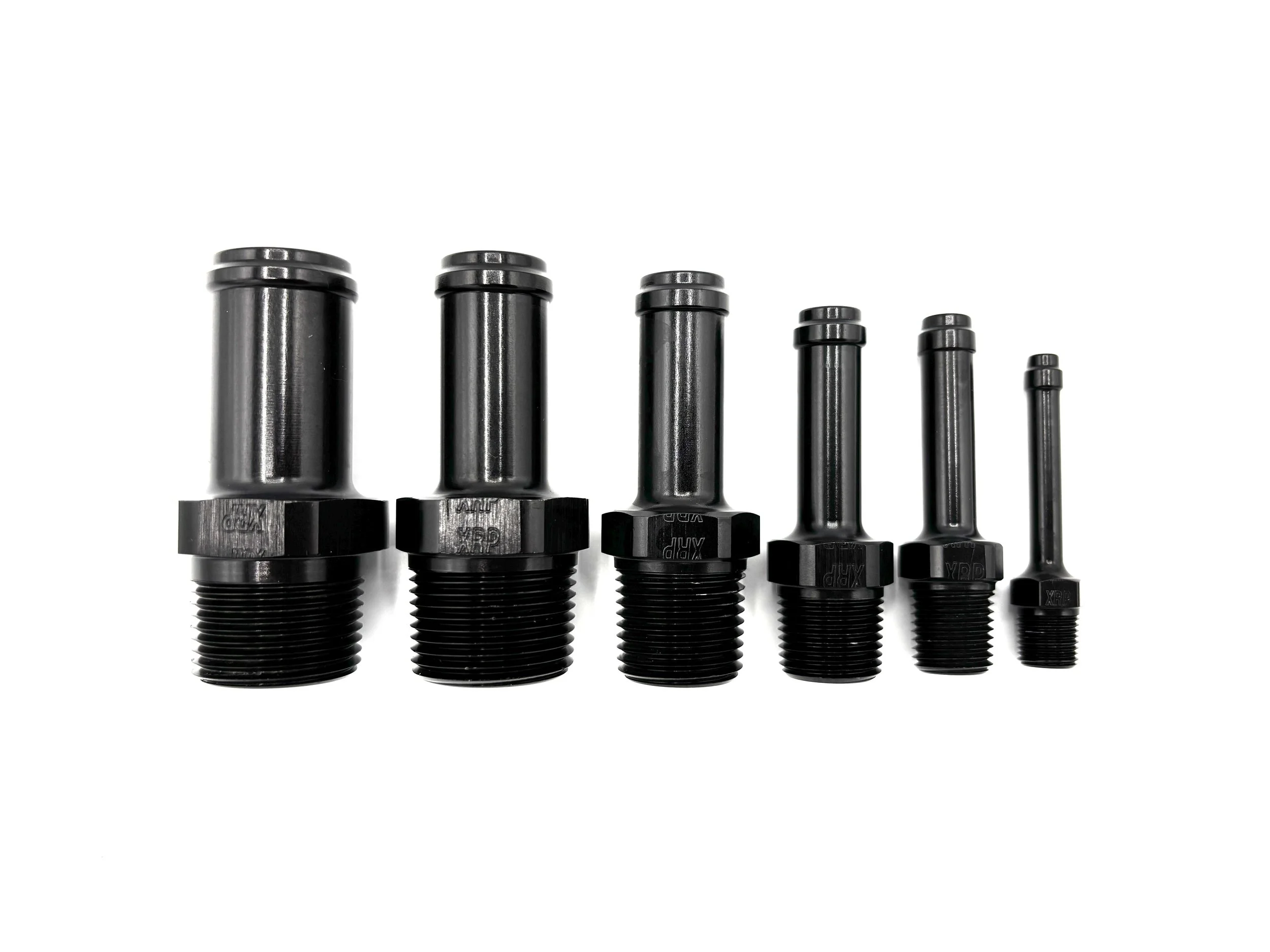 XRP straight hose Barb to NPT adapter fitting. Black in color. Various sizes from largest to smallest, left to right.