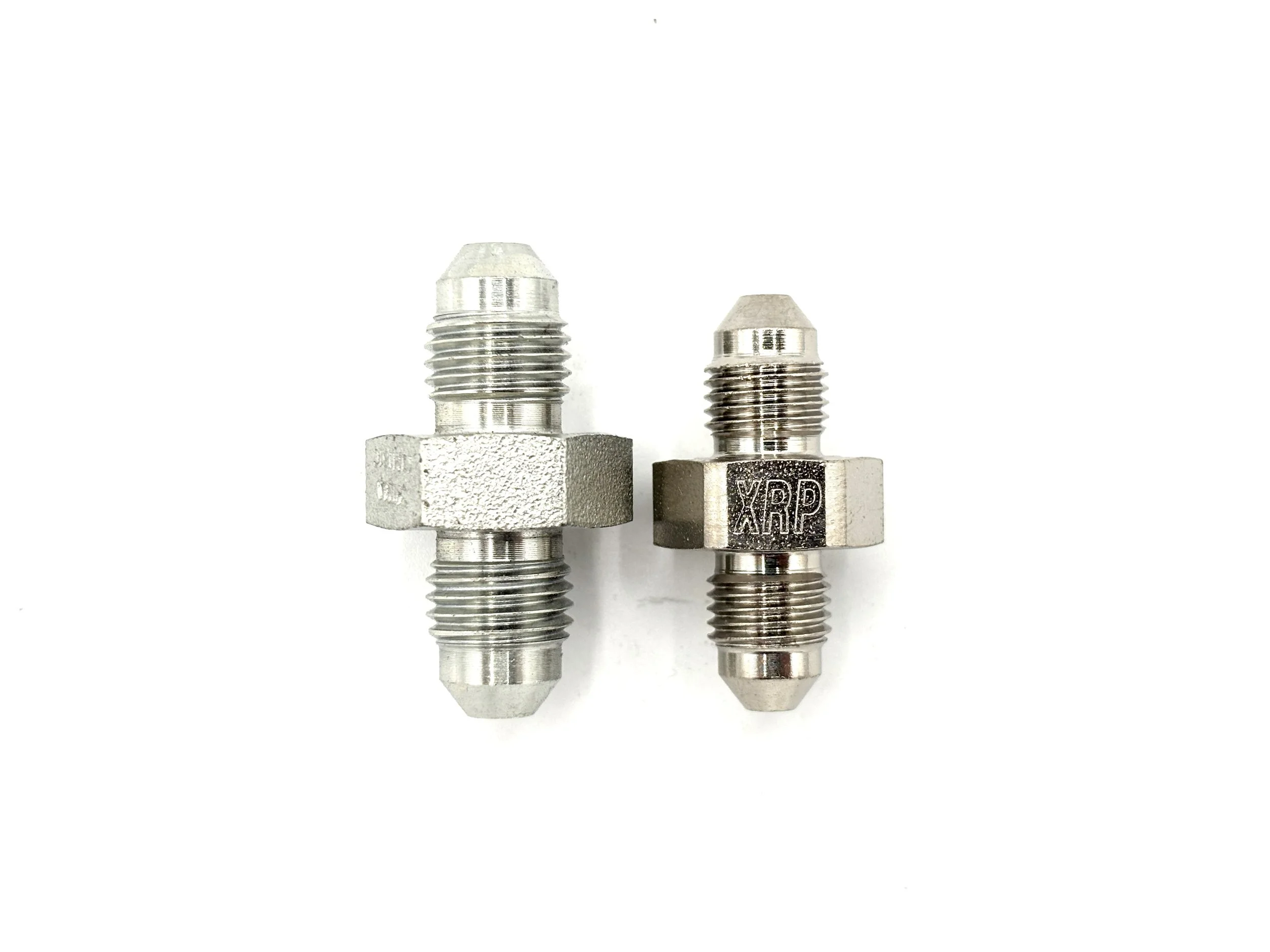 XRP AN male to male steel large hex union adapter. Silver in color. Various sizes from largest to smallest, left to right.