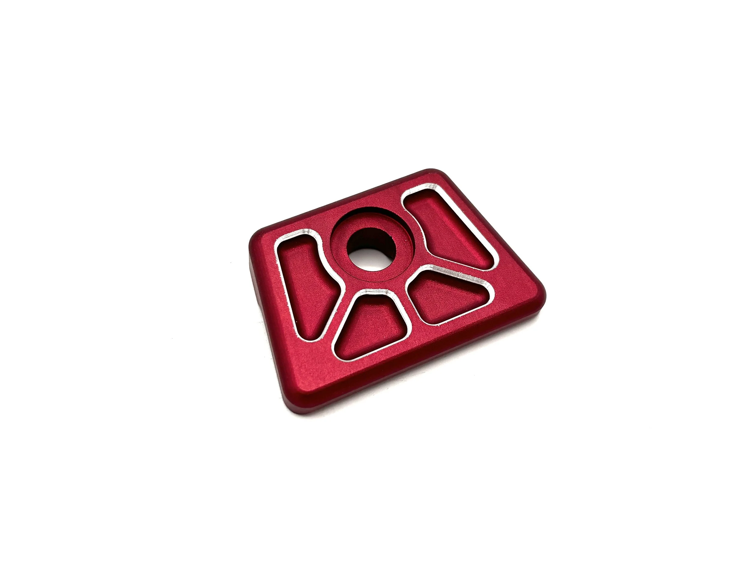 F2 VW Fuel Tank Washers. Red Exterior, has Silver color highlights on the chamfer of the bosses in the part. Trapezoid Shape with radiuses and a counter sunk hole in the middle.