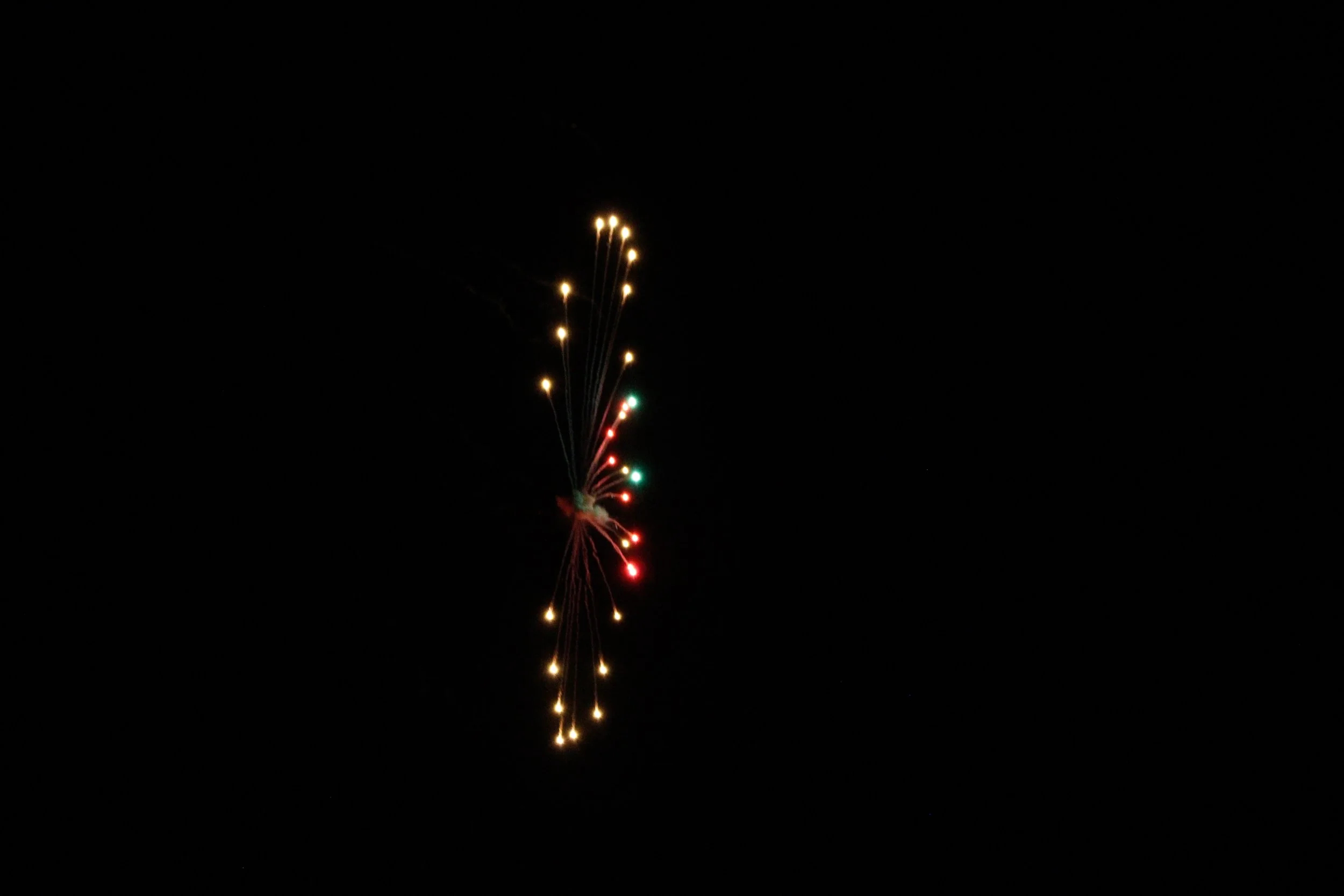 Fireworks display against a dark night sky with colorful streaks and bursts.