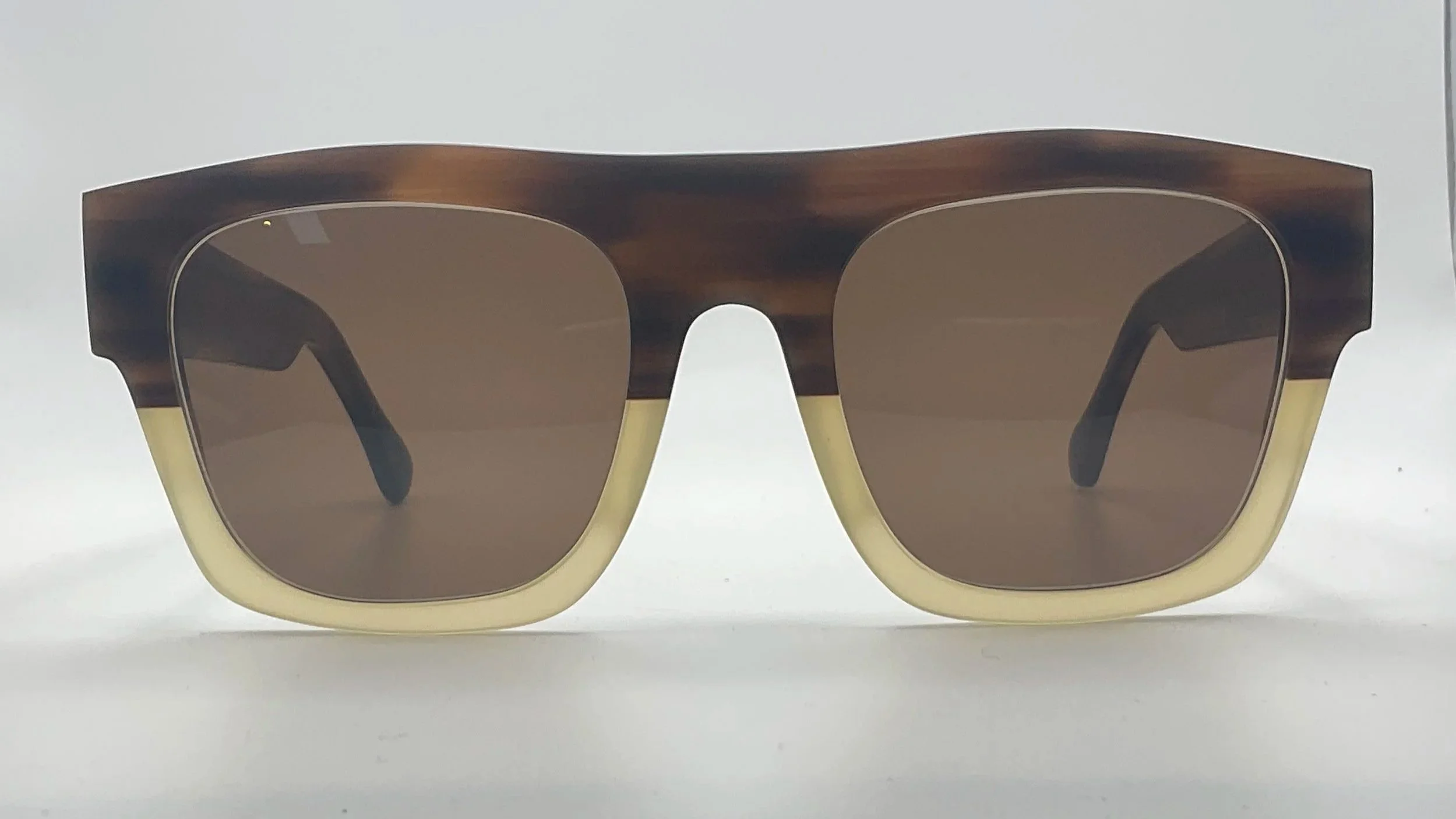 Brown and beige sunglasses with brown lenses and a woodgrain frame design.