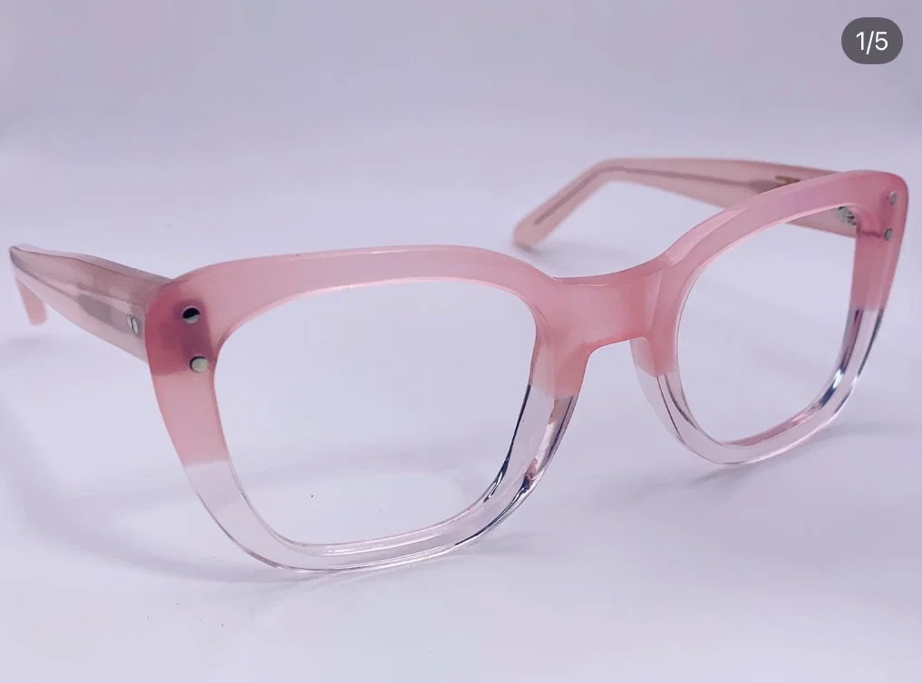 Pink and clear plastic eyeglasses with round frames on a white background.