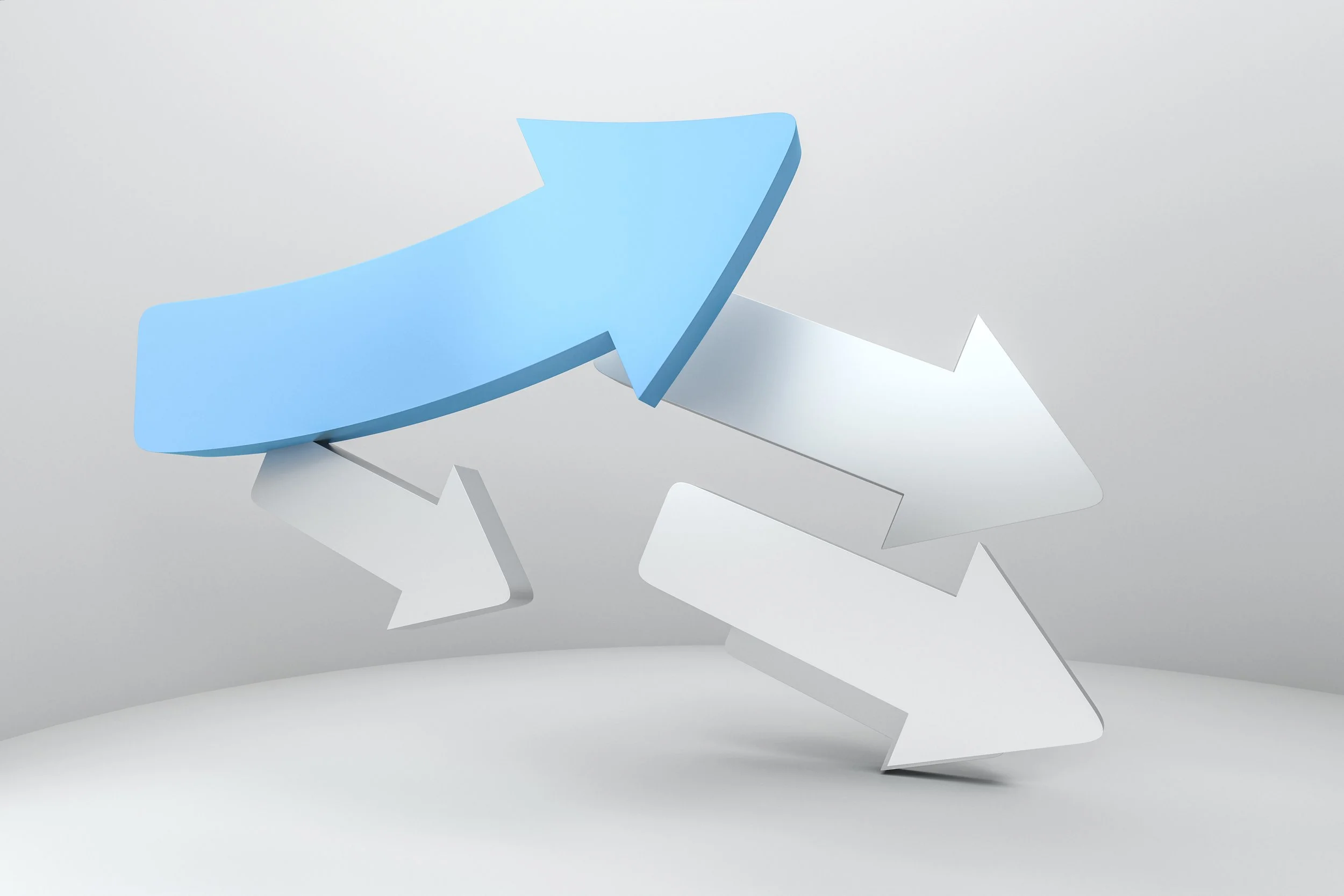 3D arrows pointing to the right in formation, except for one arrow veering up.