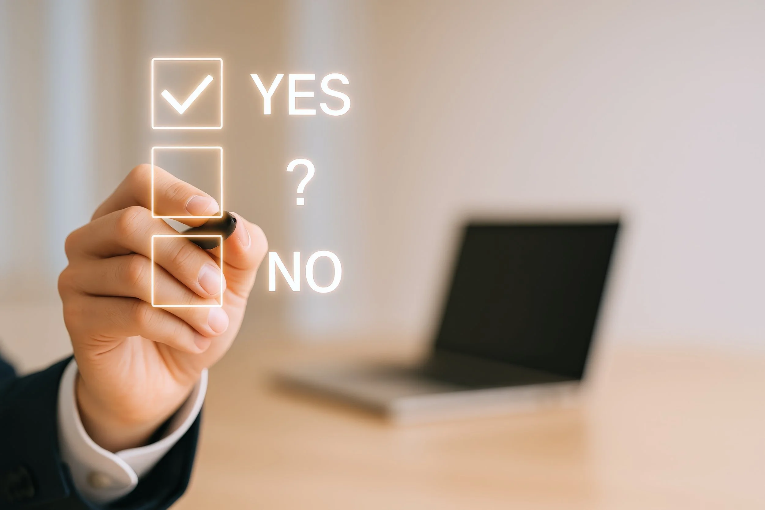 A hand holds a stylus and hovers over graphic Yes/No checkboxes.