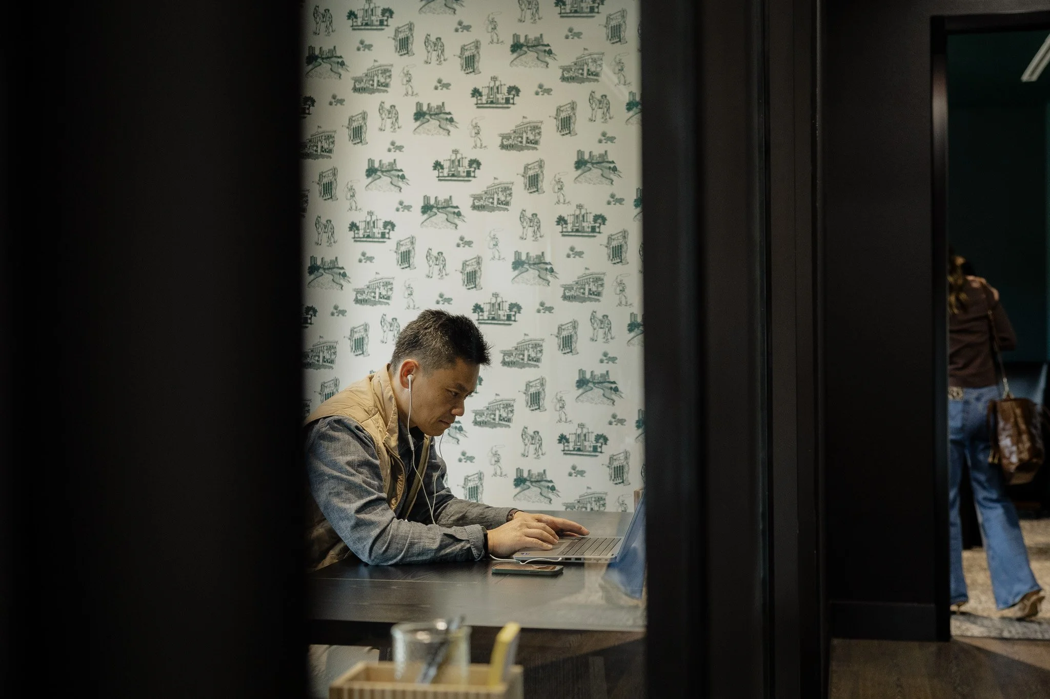 A man working on his laptop at a desk at Kings Gate in Willow Park, TX, a coworking space
