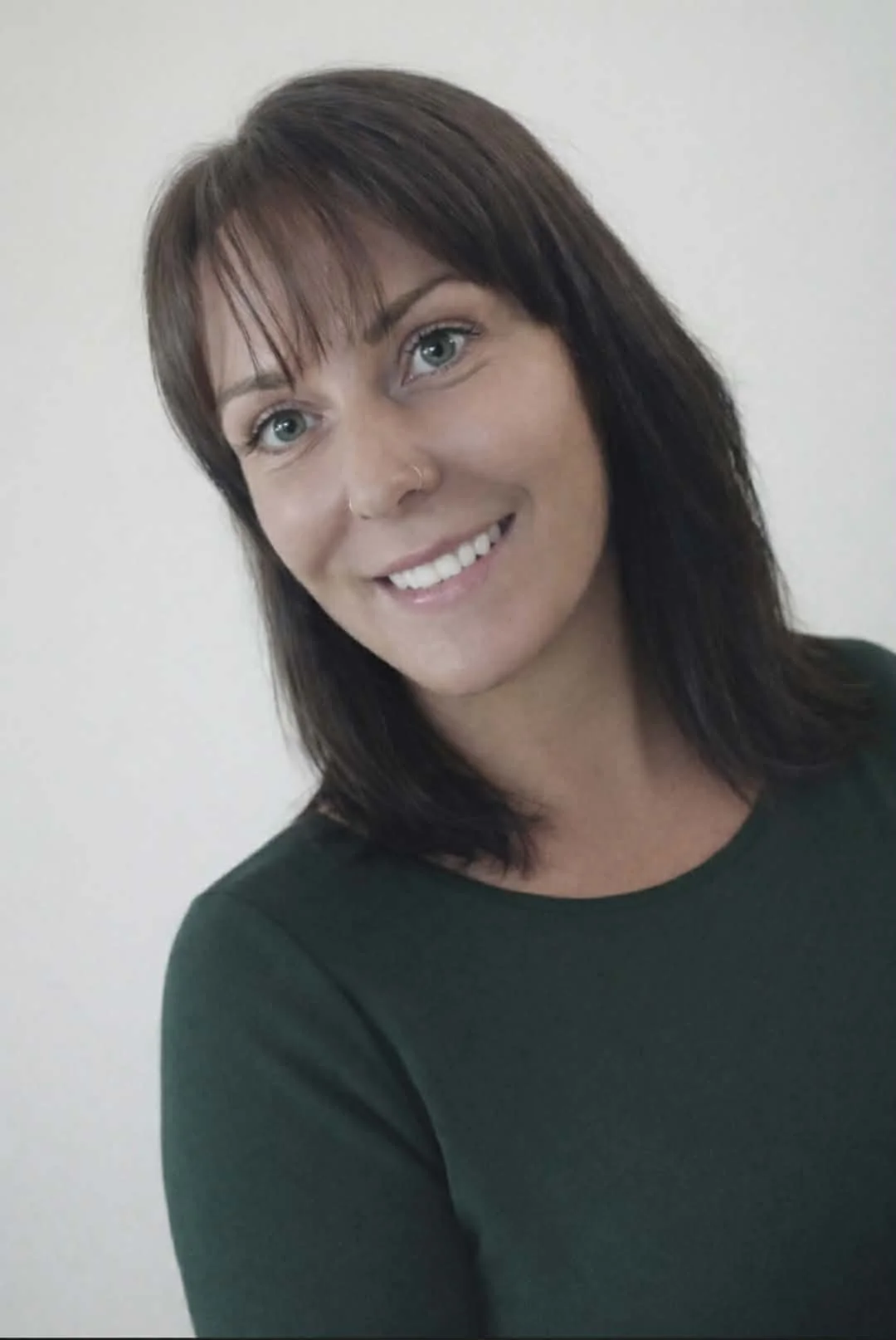 Line drawing of a house with a sun symbol inside it.