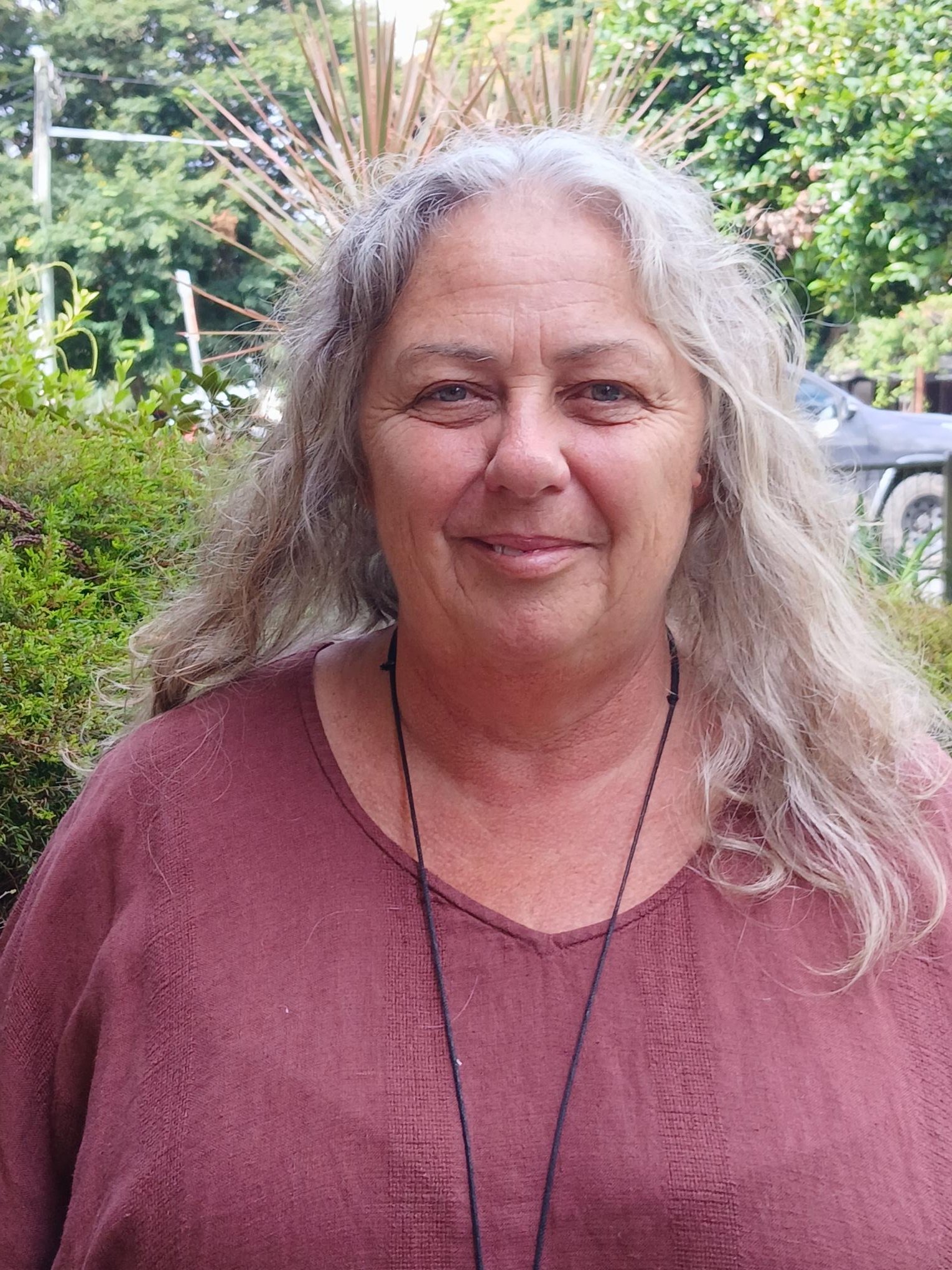 Outline of a house with a sun symbol inside.