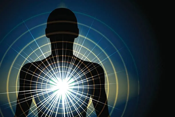 Male silhouette with bright heart light emanating from the center of the chest