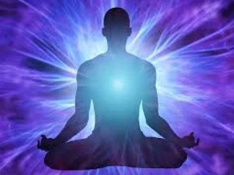 Silhouette of a person in a meditative yoga pose with glowing light behind them, surrounded by purple and blue energy patterns.