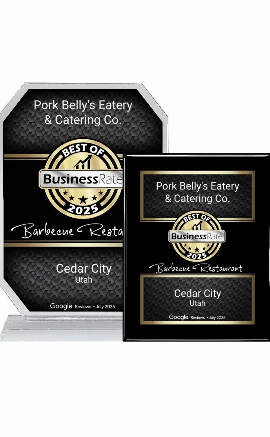 Award plaques for Pork Belly's Eatery & Catering Co., recognizing it as a best barbecue restaurant in Cedar City, Utah, based on Google reviews in July 2025.