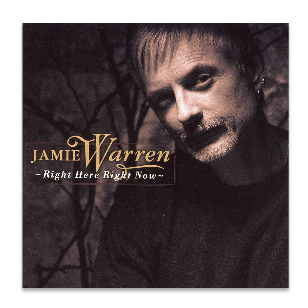 Album cover featuring a black and white photo of Jamie Warren with short hair, beard, and earrings, against a dark background with branches. Text reads 'Jamie Warren - Right Here Right Now'.