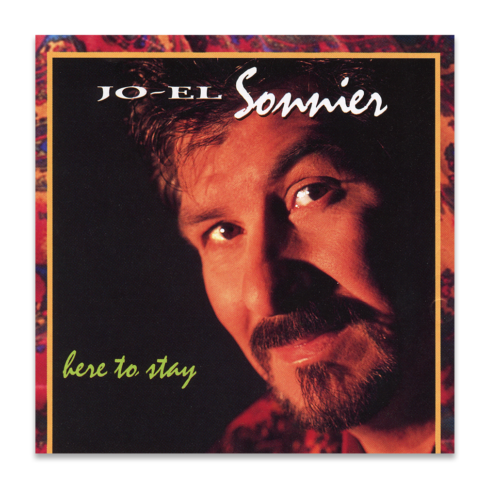 Album cover featuring a close-up photo of a man with dark hair, a mustache, and a beard, with the text 'Jo-El Sommer' at the top and 'here to stay' at the bottom left corner.