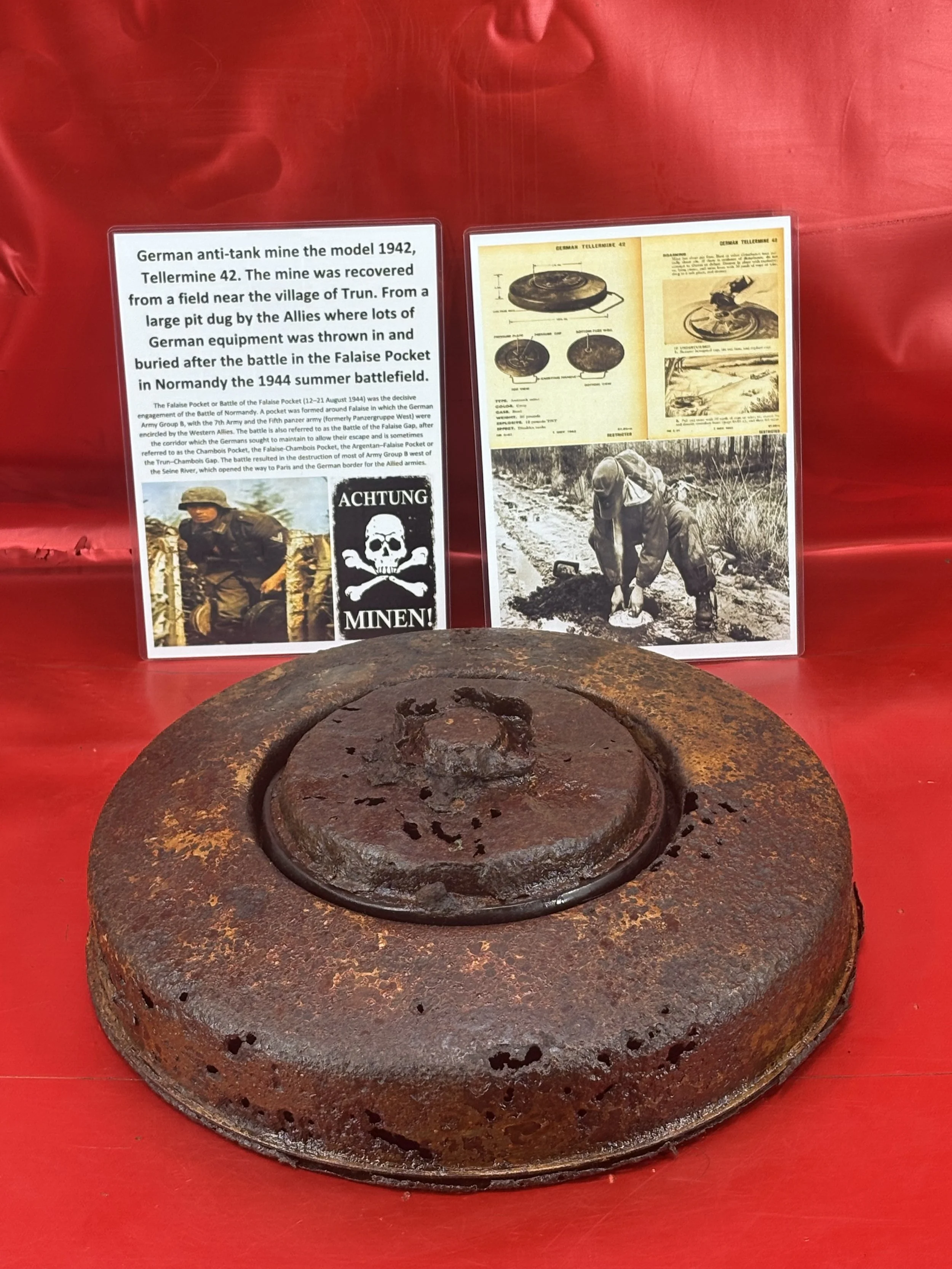 Nice German Anti Tank Tellermine 42 complete with its base plate also with lots of sand colour paintwork and red undercoat recovered from a field near Trun in the Falaise Pocket in Normandy 1944