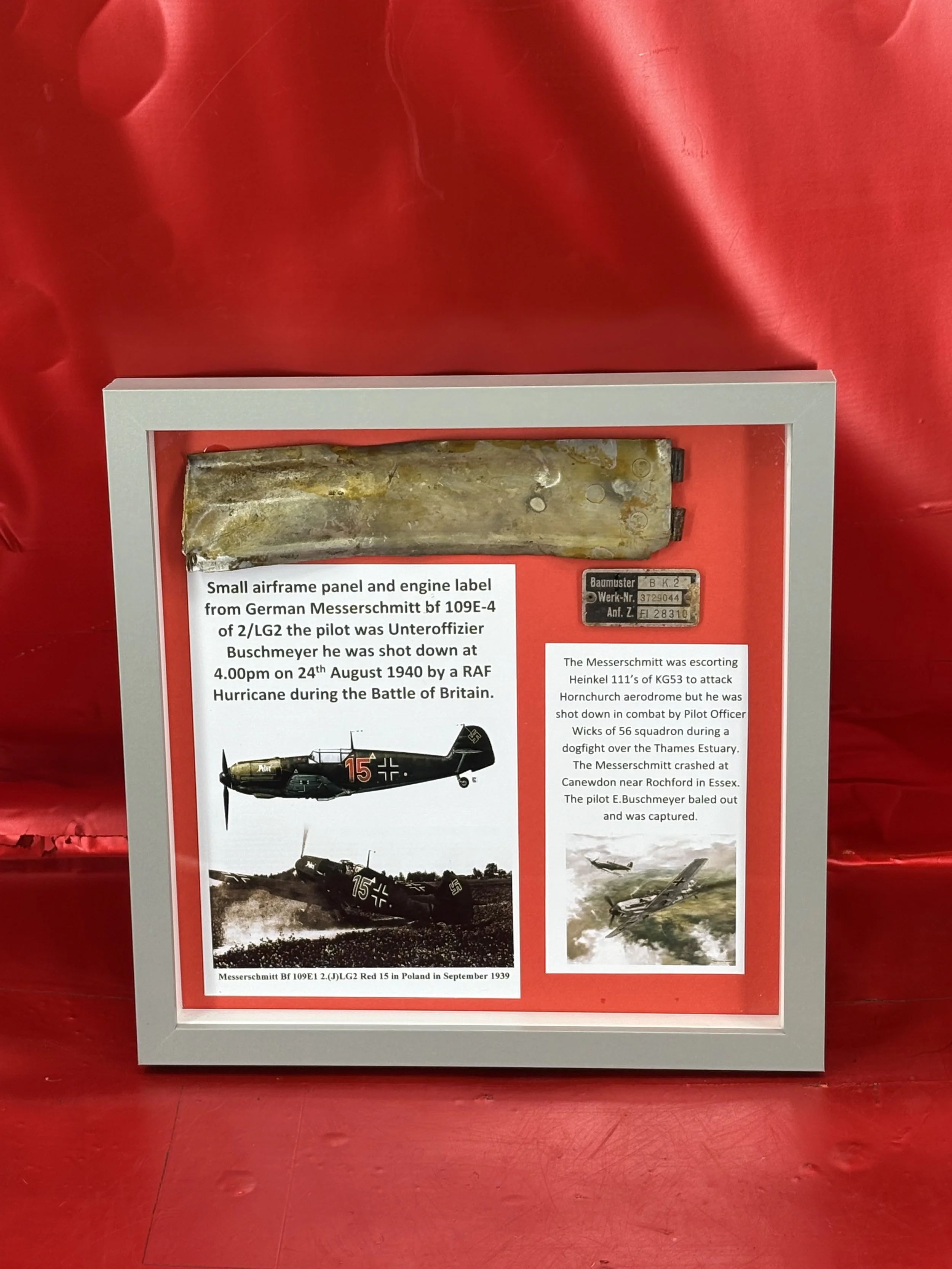 Glass framed small airframe panel and lovely engine label from German Messerschmitt bf 109E-4 of 2/LG2 the pilot, Unteroffizier Buschmeyer, shot down on 24th August 1940, Rochford,Essex